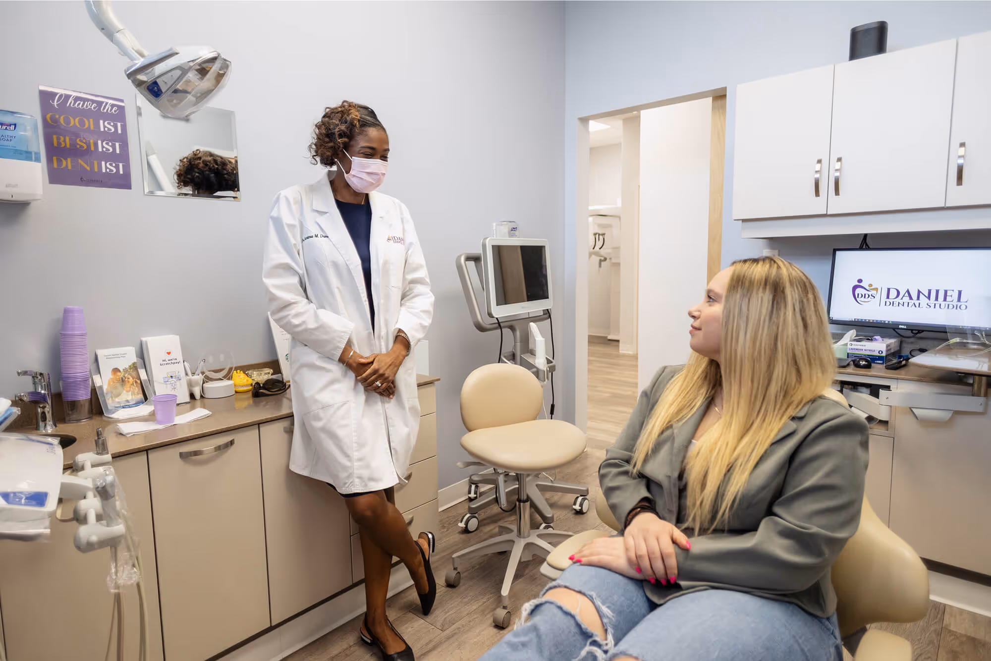 A woman in a white lab coat talking to a woman in a white lab coat.