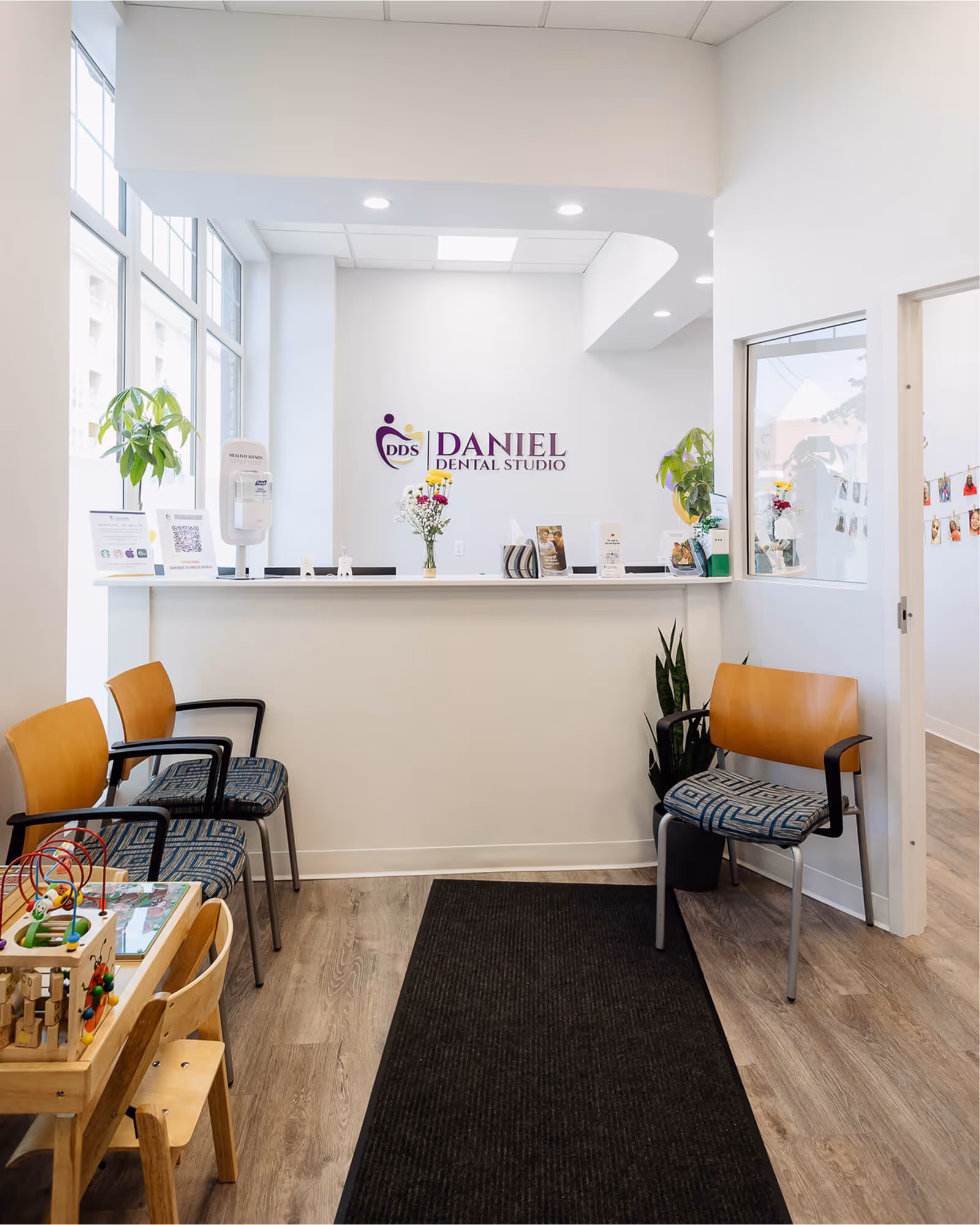 The front desk of a nail salon with chairs.