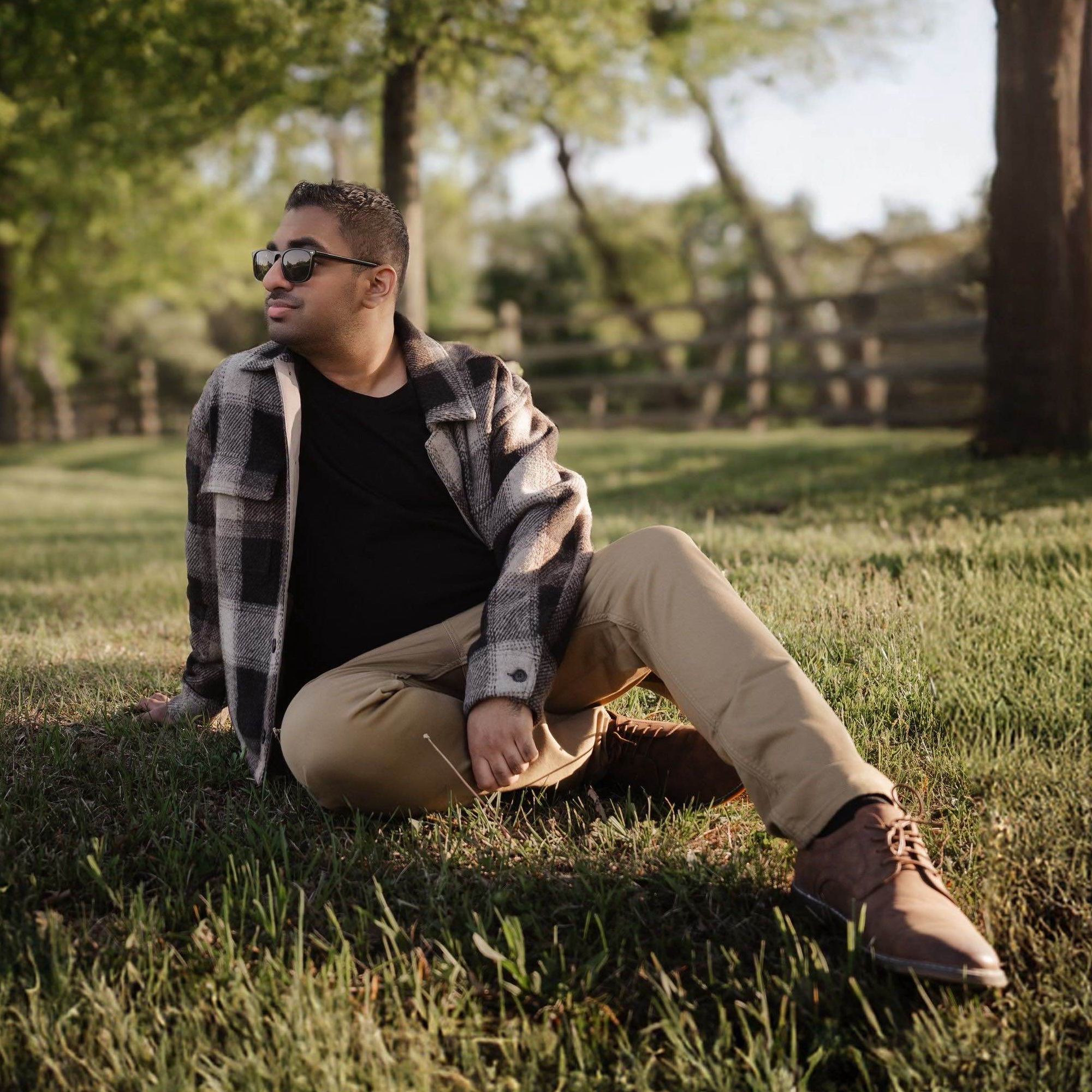 Artist Sitting in a grass field