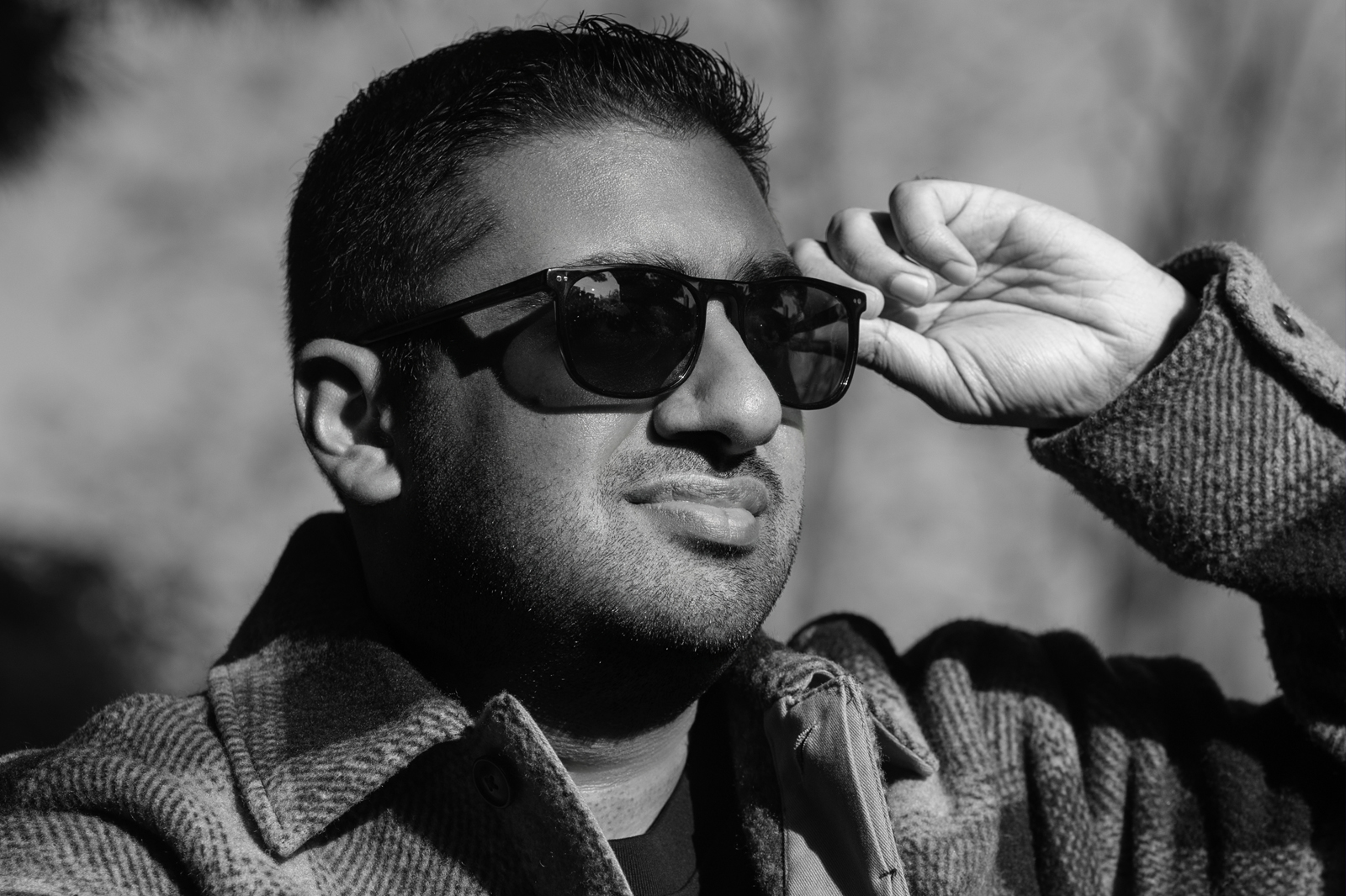 artist holding his glasses and staring into the distance