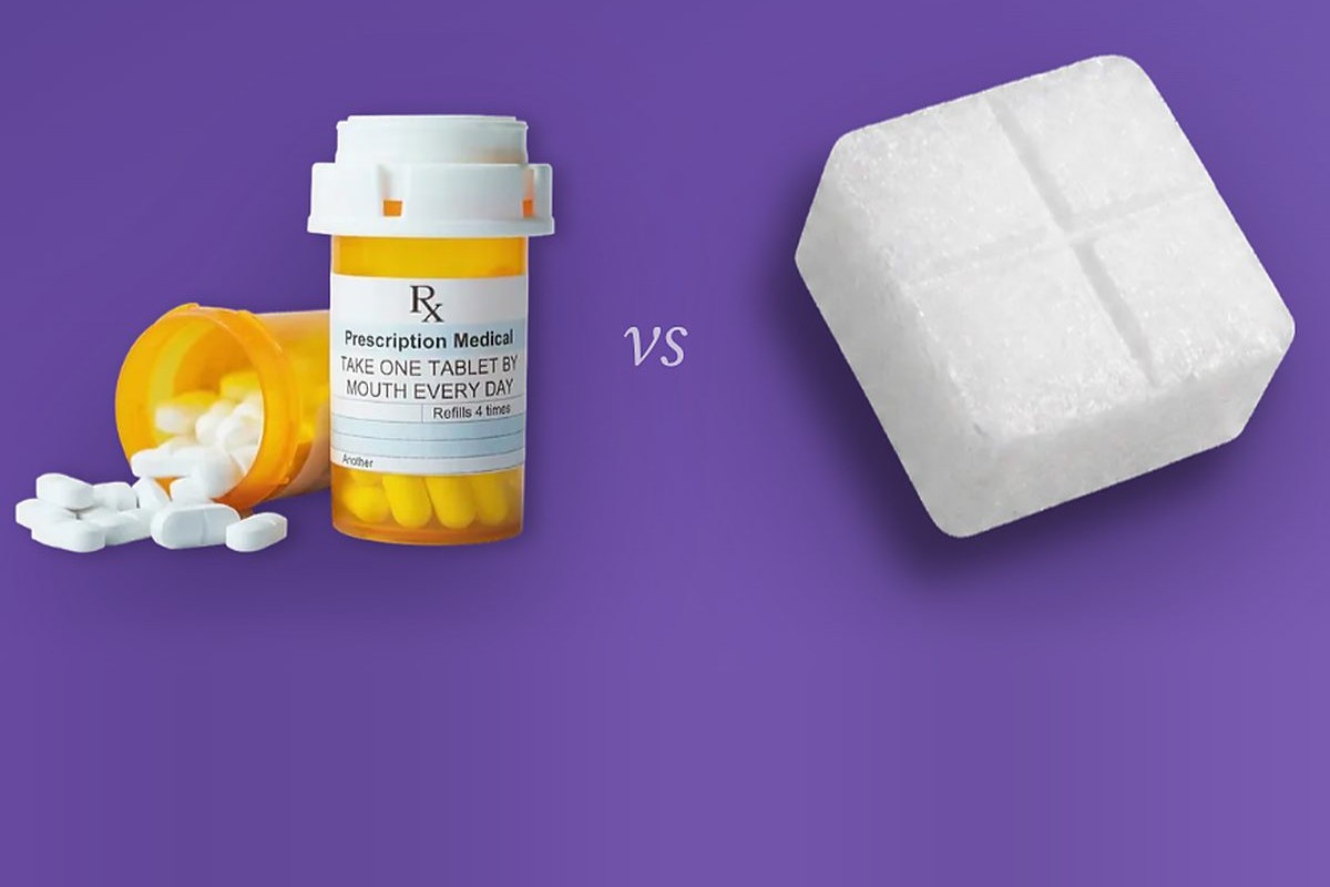A prescription pill bottle beside a Joyous ketamine troche
