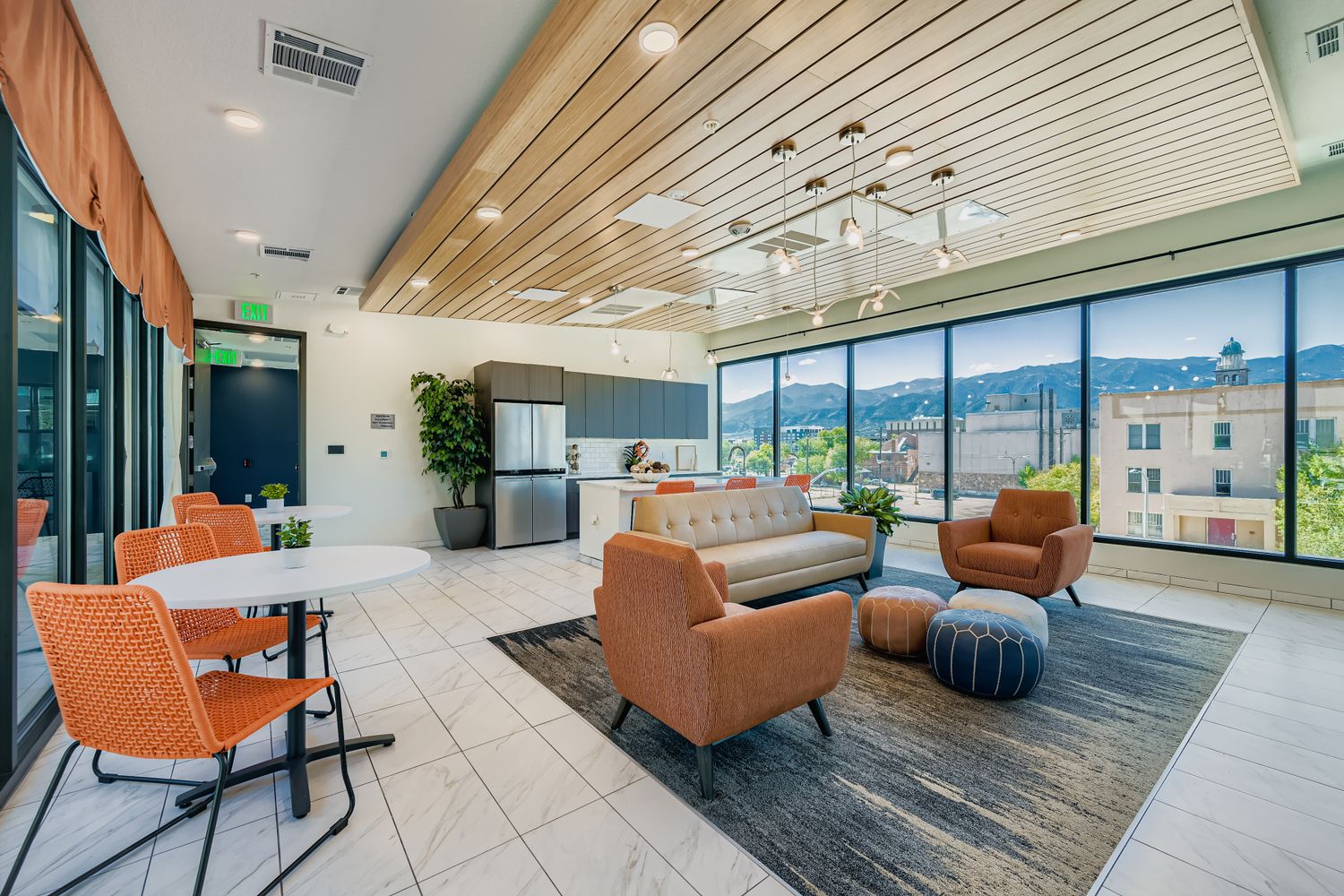 Sky lounge and community room with stunning mountain views, a full kitchen, and comfortable seating at Avian Apartments in Colorado Springs, CO.