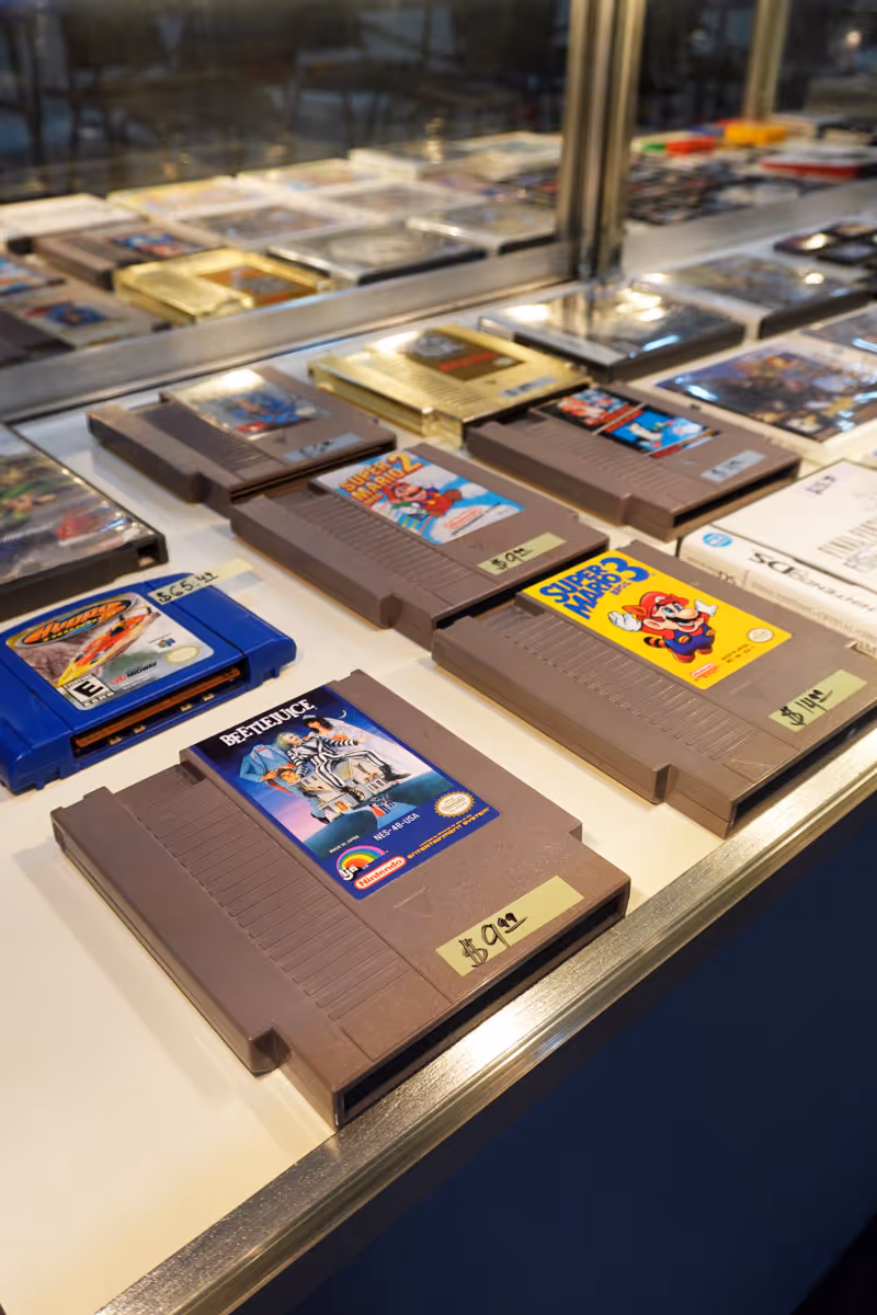 A close up picture of a display case full of Nintendo cartridges.