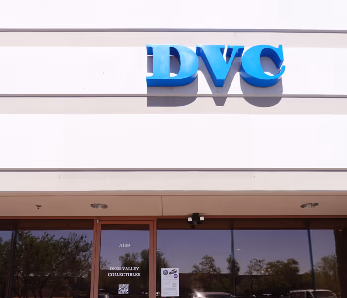 The storefront of Deer Valley Collectibles, featuring a bright blue sign that reads "DVC."