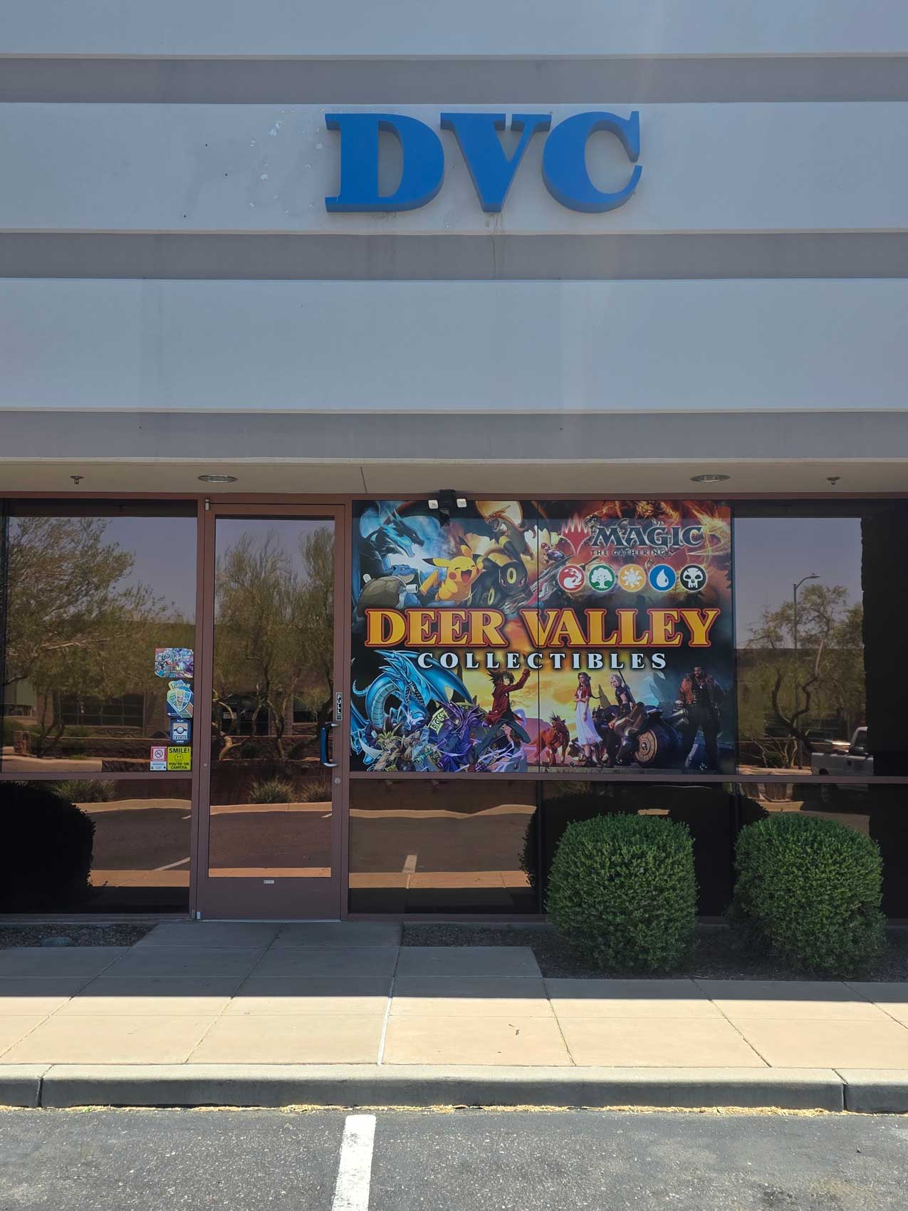 Storefront with a sign reading Deer Valley Collectibles and featuring Magic the Gathering and Pokémon characters.