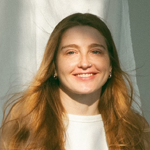A woman with long blonde hair is smiling