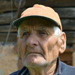 Older man with hat and glasses