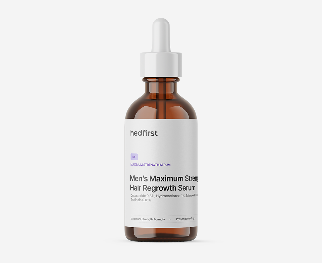 Dropper bottle labeled hair regrowth compound serum for men with FDA-certified treatment.