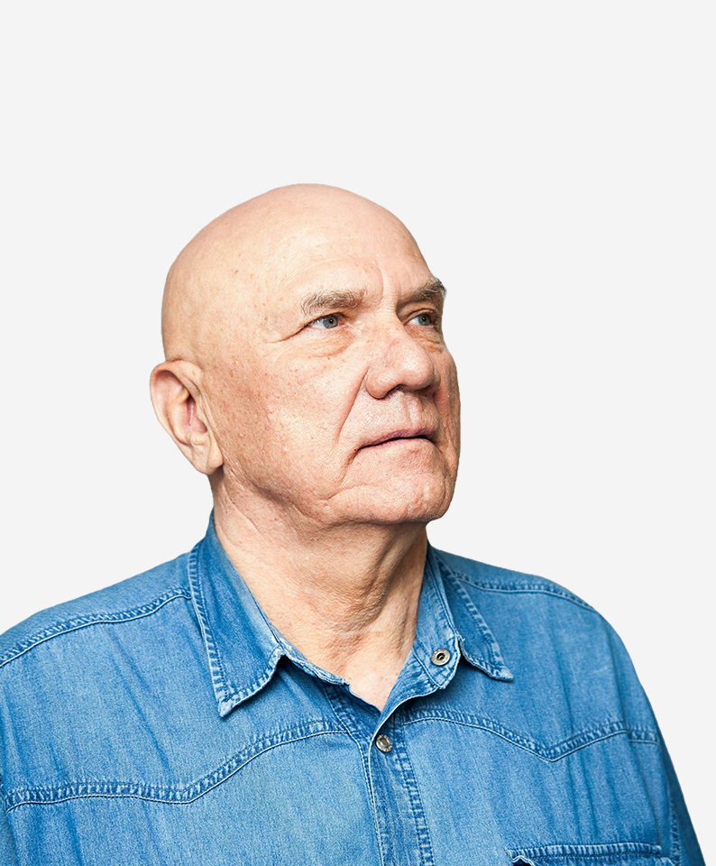 Elderly man in denim shirt looking concerned, preparing for a doctor visit.