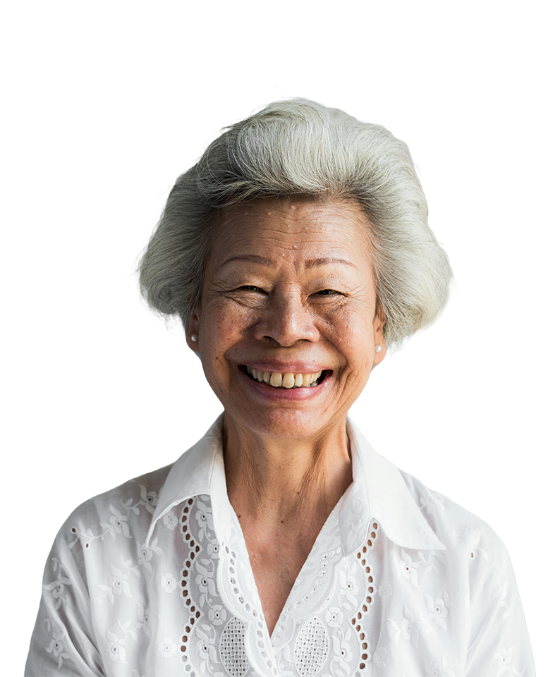 An elderly woman with gray hair and a wide smile, wearing a white blouse.