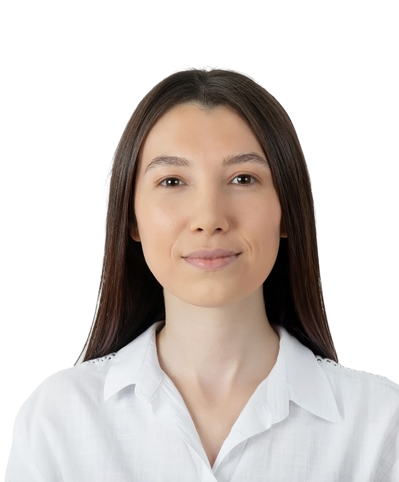 A young woman with straight dark hair looks straight ahead with a slight smile.