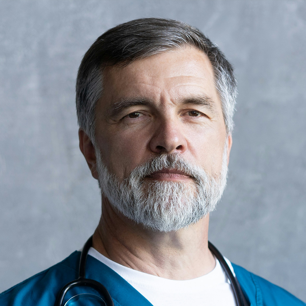 Portrait of male medical professional with gray beard