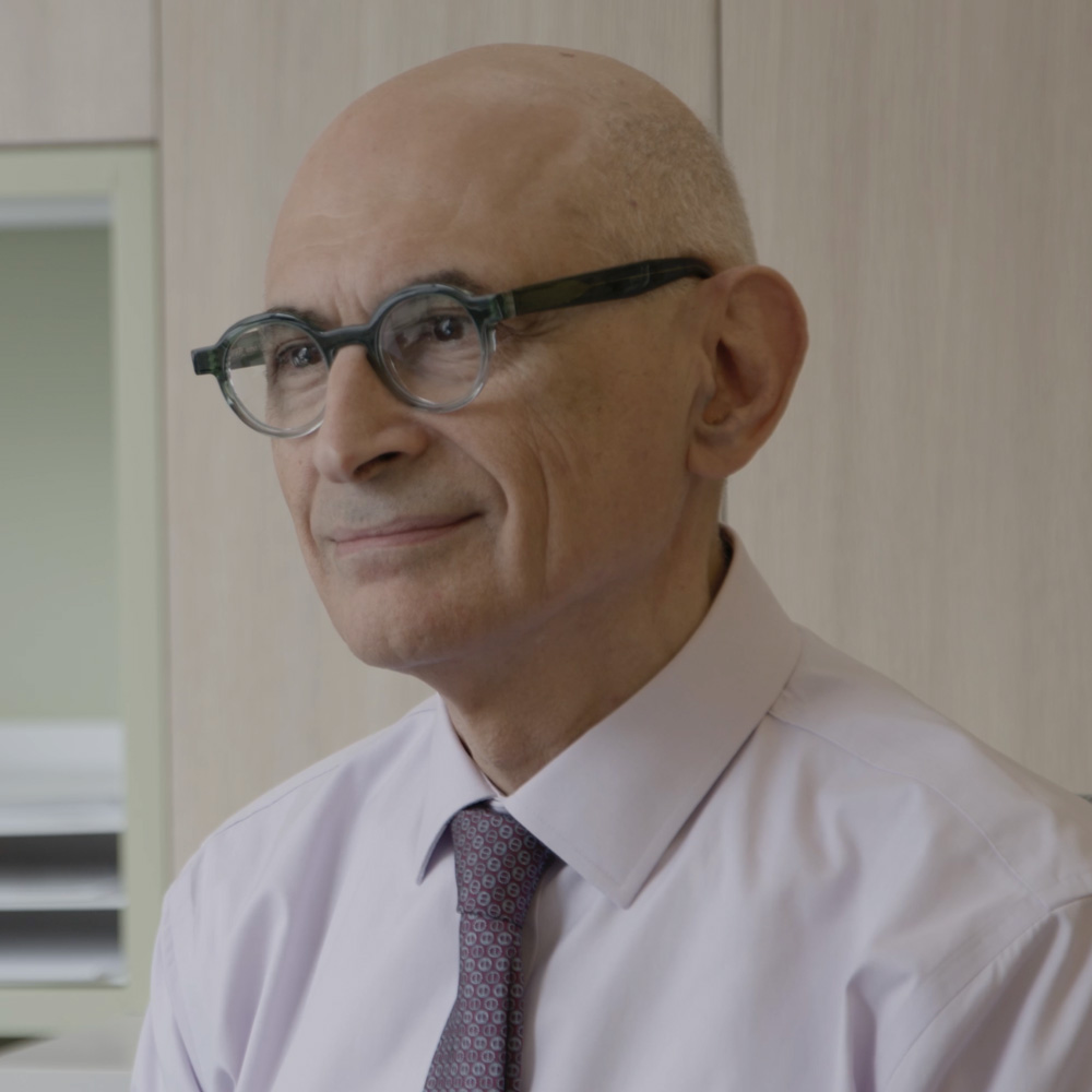 Dr. Alex Mauskop — senior man wearing glasses and a light purple shirt, Chief Medical Advisor at Hedfirst.