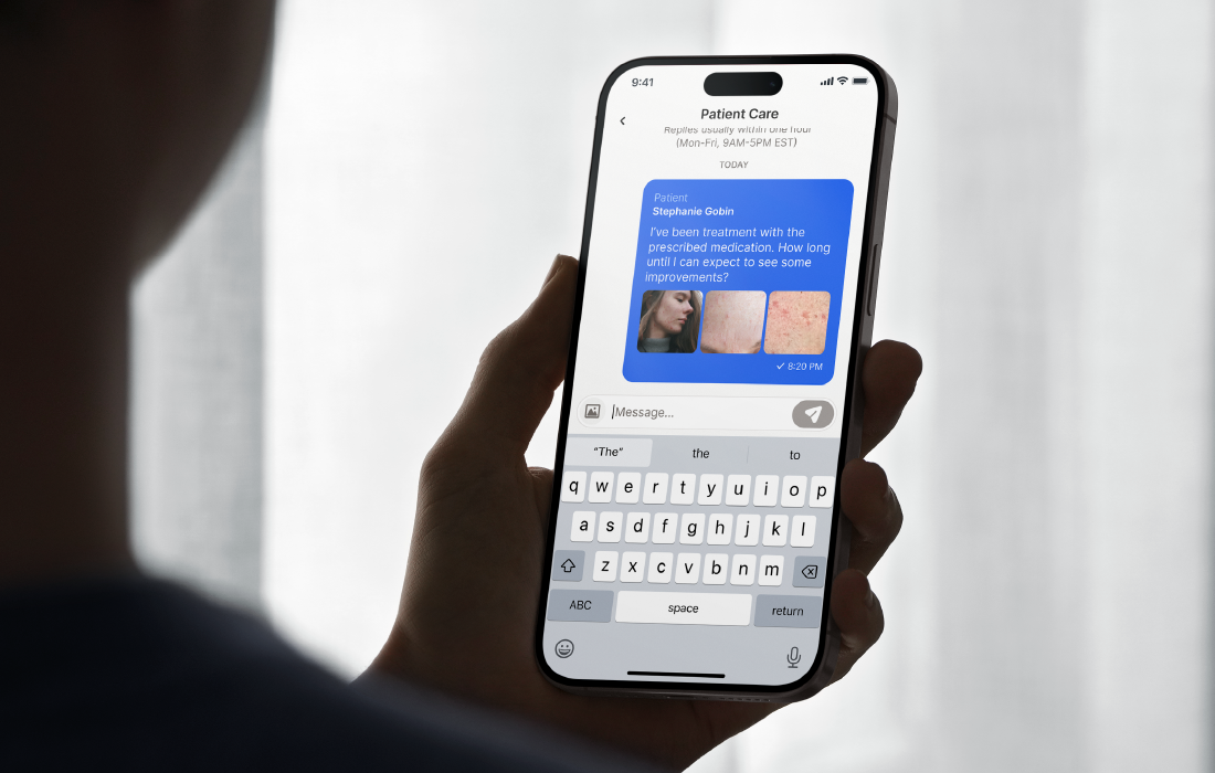 A person holding a smartphone with a patient support chat open, showing a conversation about treatment progress.