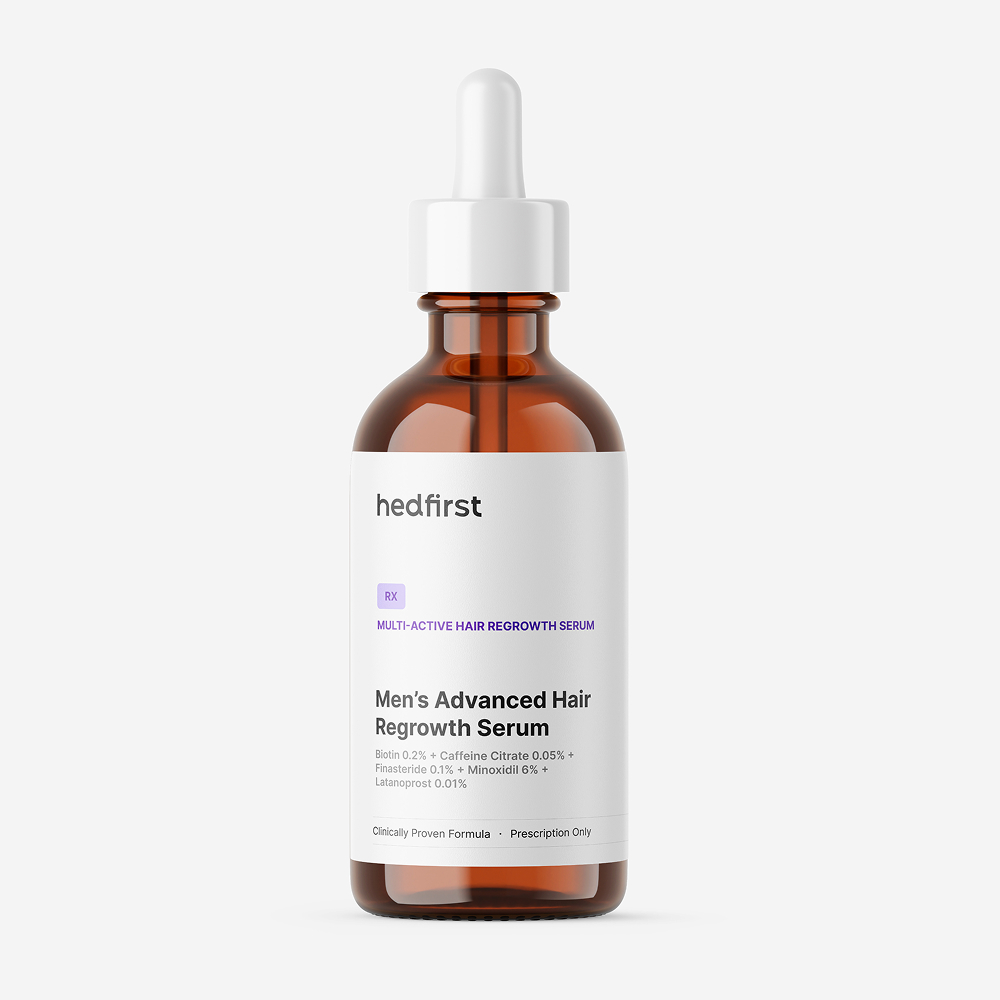 Amber glass bottle with dropper labeled Hedfirst Men's Advanced Hair Regrowth Serum on white surface.