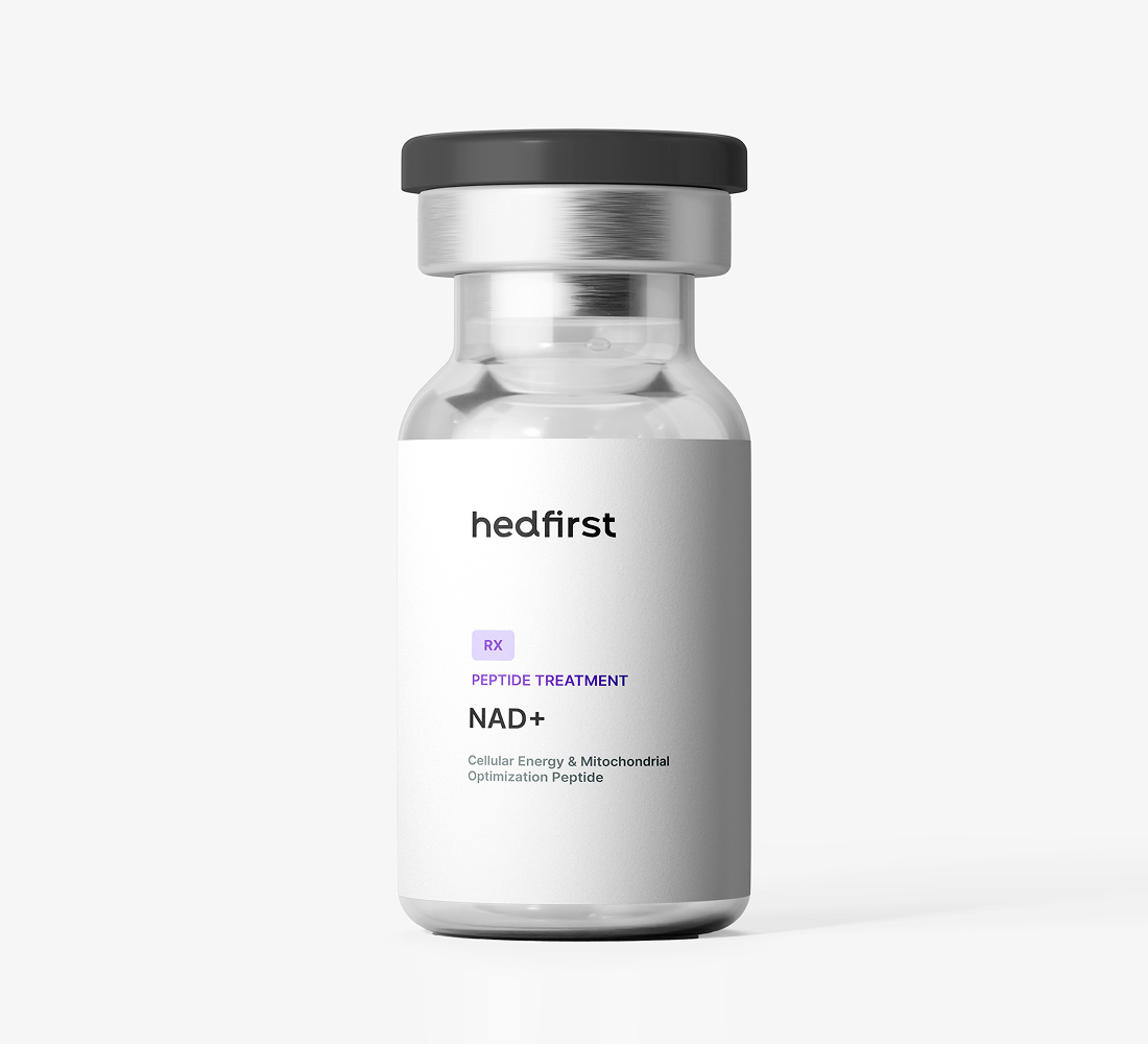 Small clear glass vial with black cap labeled Hedfirst NAD+ peptide treatment on white background.