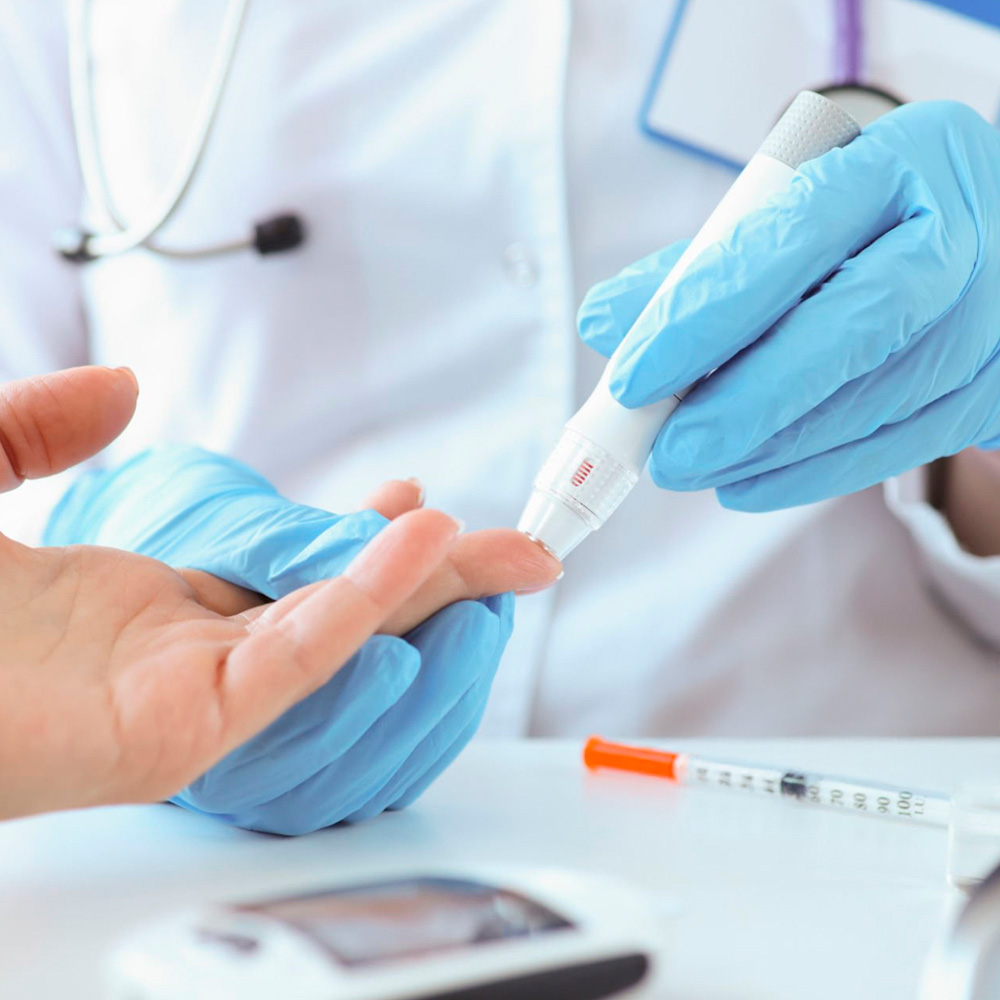 Healthcare provider performing finger-prick blood test for cholesterol screening.