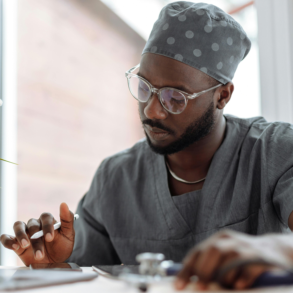 Focused doctor reviewing patient notes with digital tablet.