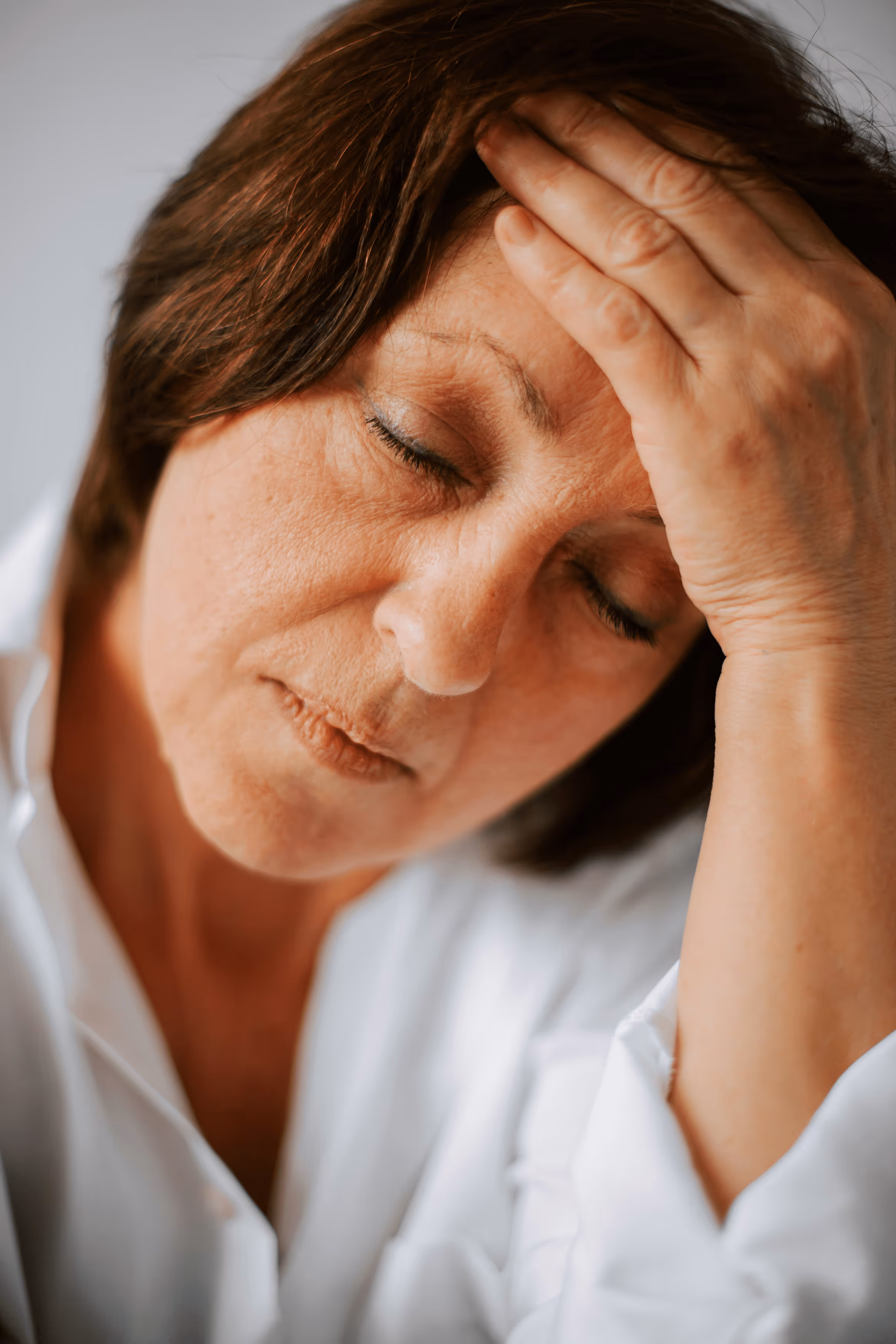 Older man coughing and holding chest, showing signs of chronic cough.