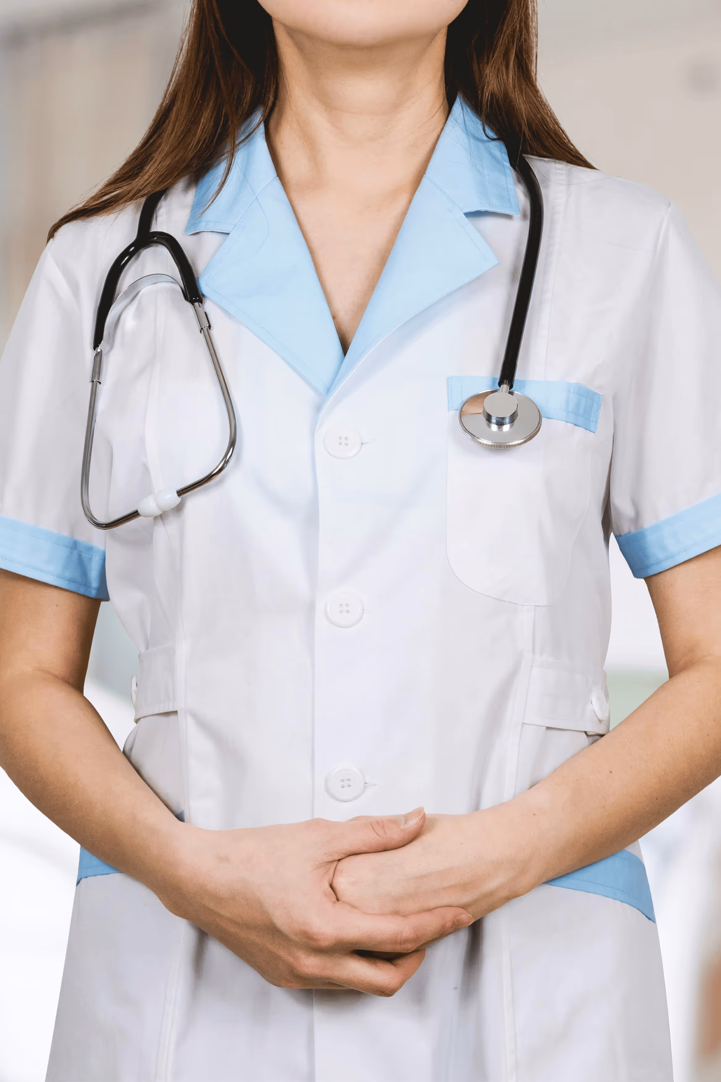 Female doctor with headset writing notes during telehealth consultation.