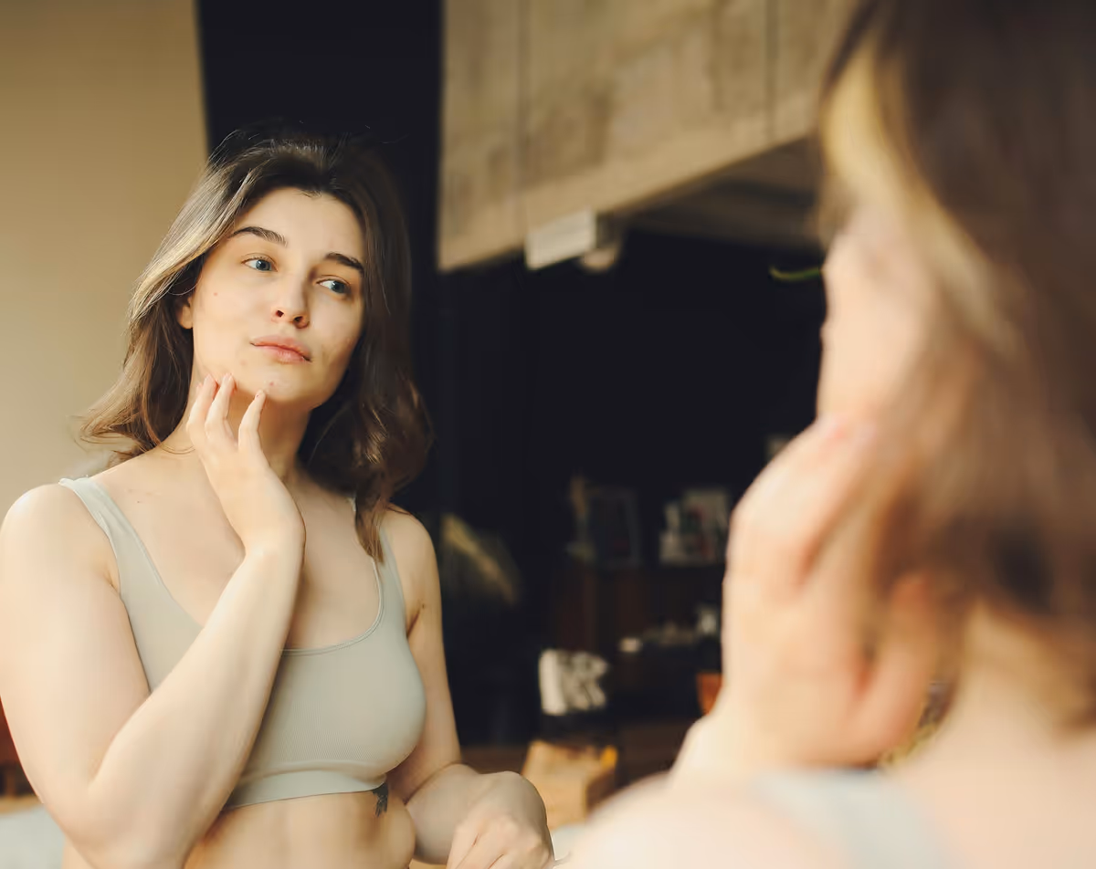 Woman touching her neck representing thyroid imbalance and effective treatment solutions.