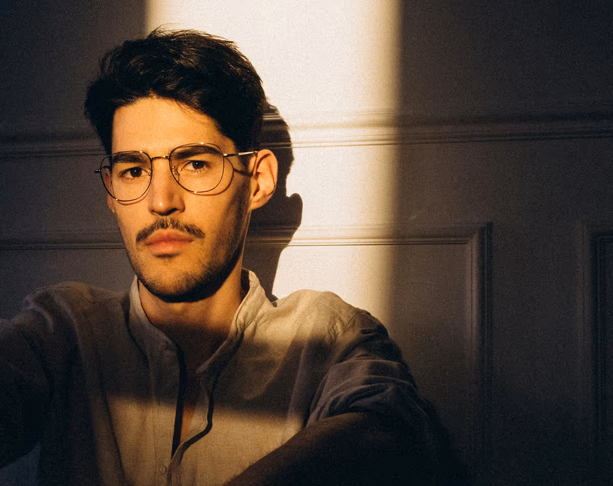 Close-up of man with glasses showing thicker, healthier hair after Hedfirst prescription treatment.