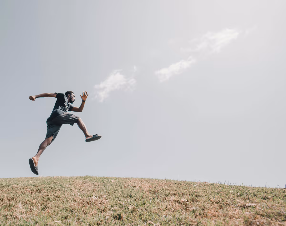 Active man jumping high with restored energy and vitality from Hedfirst treatment.