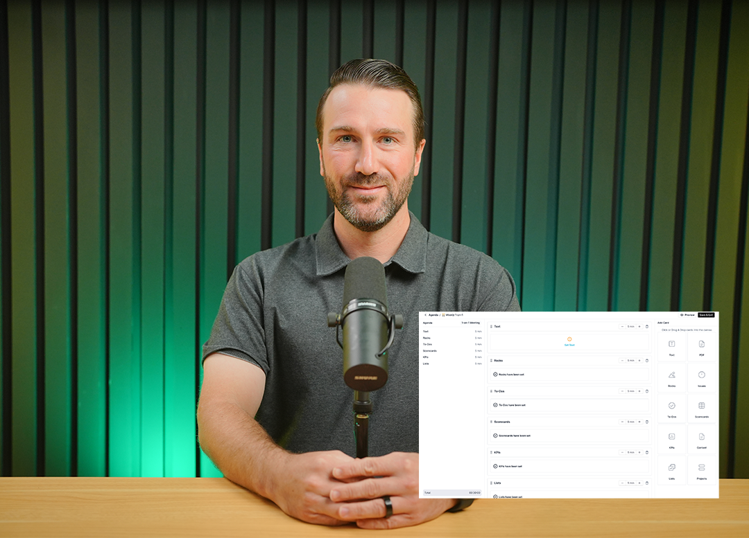 A man with short dark hair and beard sitting at a desk, speaking into a microphone with a vertical striped green background and a meeting agenda interface overlay.