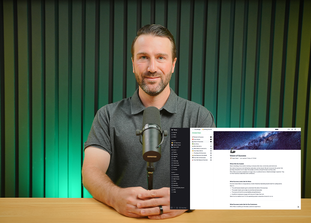 Man with a beard sitting at a wooden table speaking into a microphone with a digital screen overlay of a project management software.