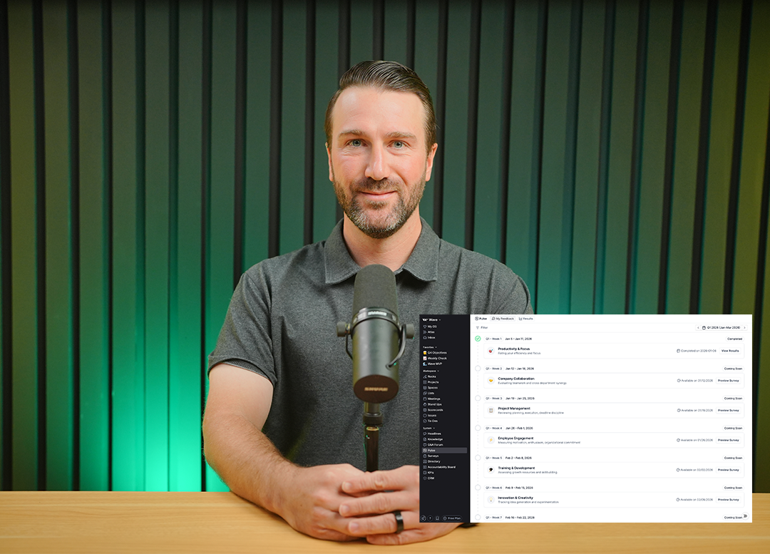 Man in a gray polo shirt sitting at a wooden table with a microphone in front, with a software dashboard overlay showing productivity and project management tasks.