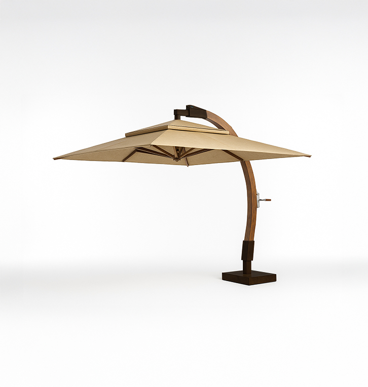A large beige patio umbrella with a curved wooden pole and a dark rectangular base.