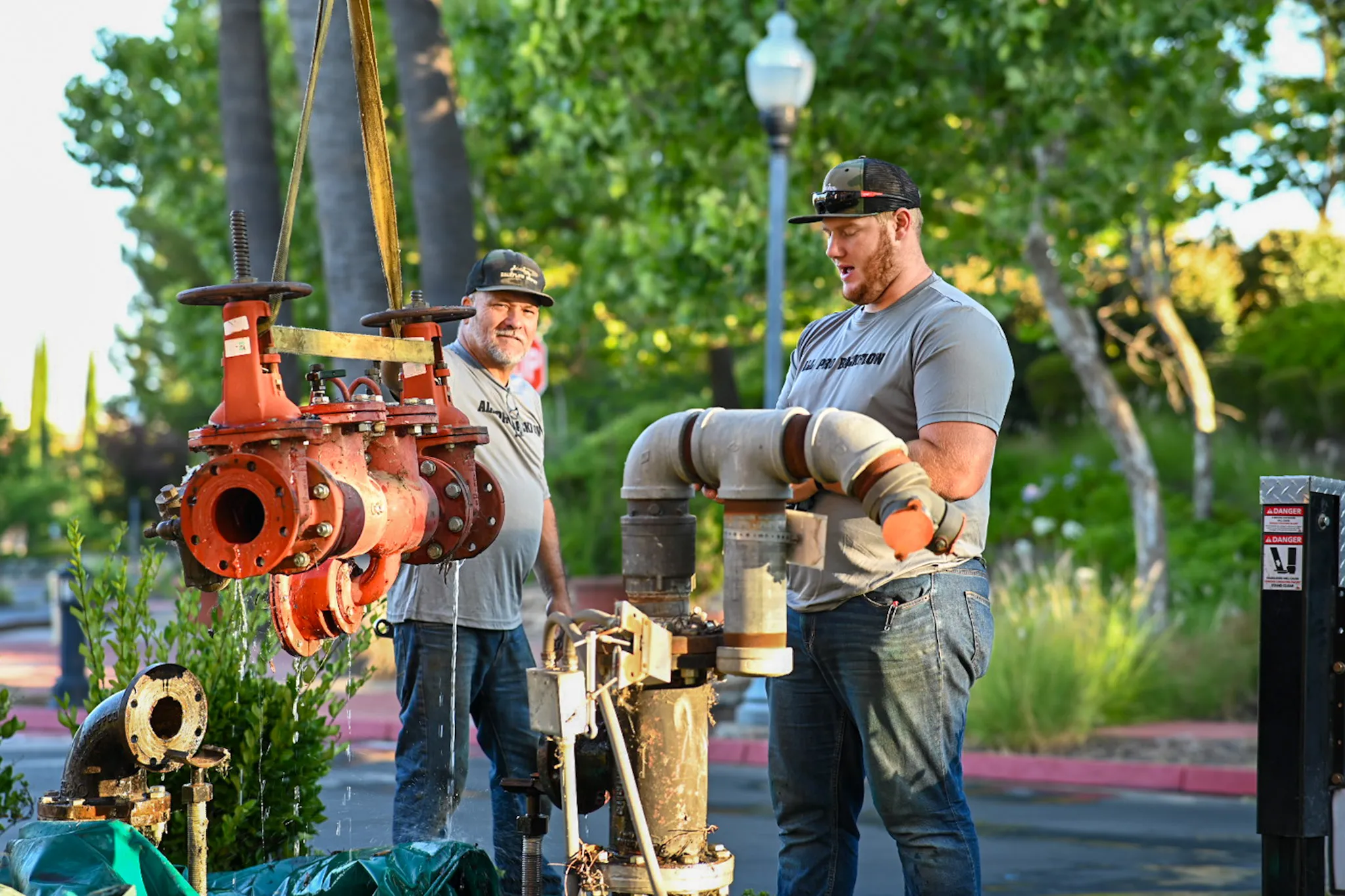 Image of two men working