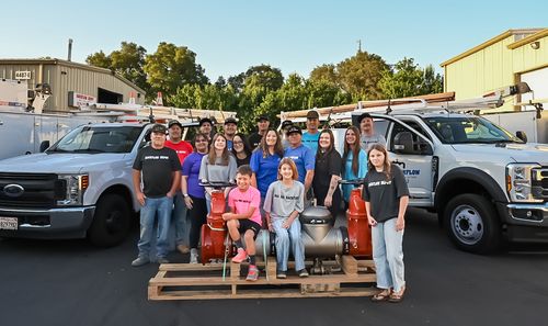 Image of two men working