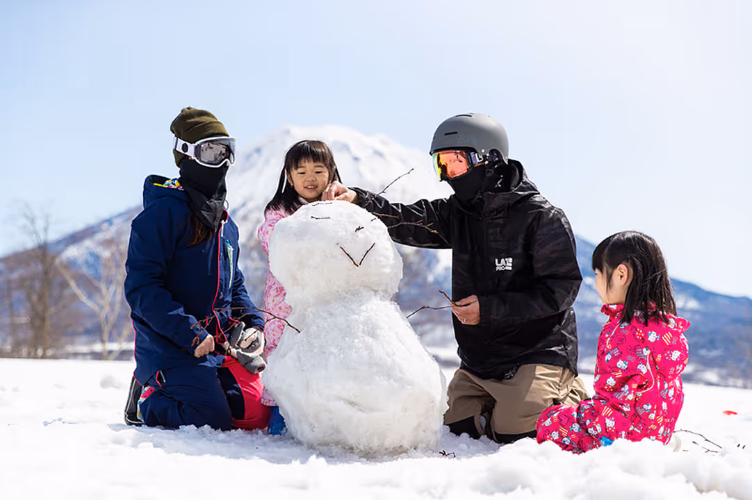 Family building a snowman