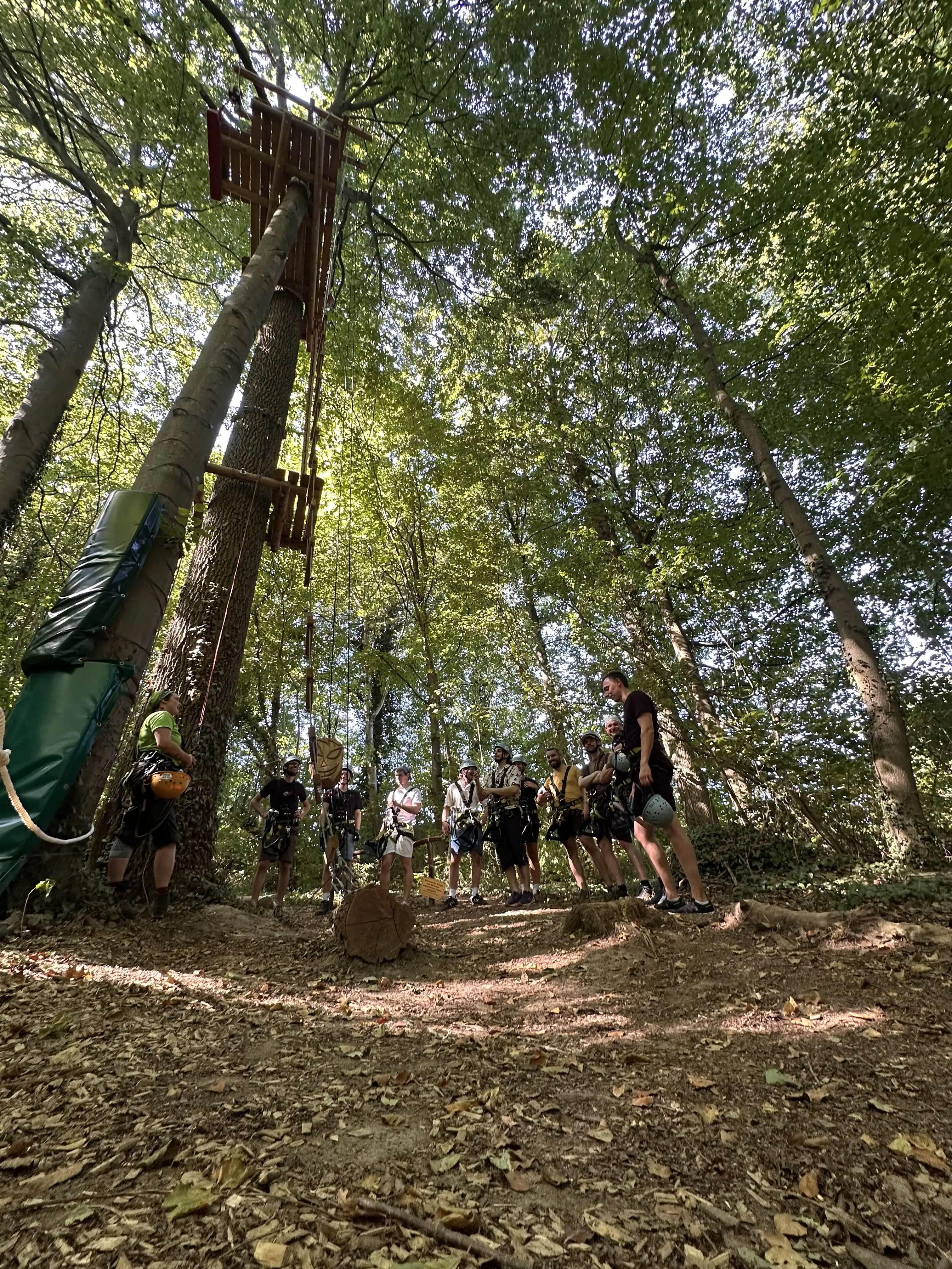 Group receiving instructions in front of a 12-meter platform at the Turmberg high ropes course