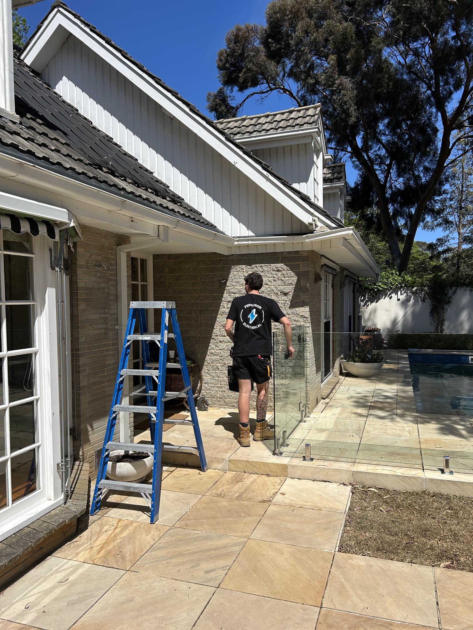 Electrician installing modern pendant lights during a home renovation in Melbourne