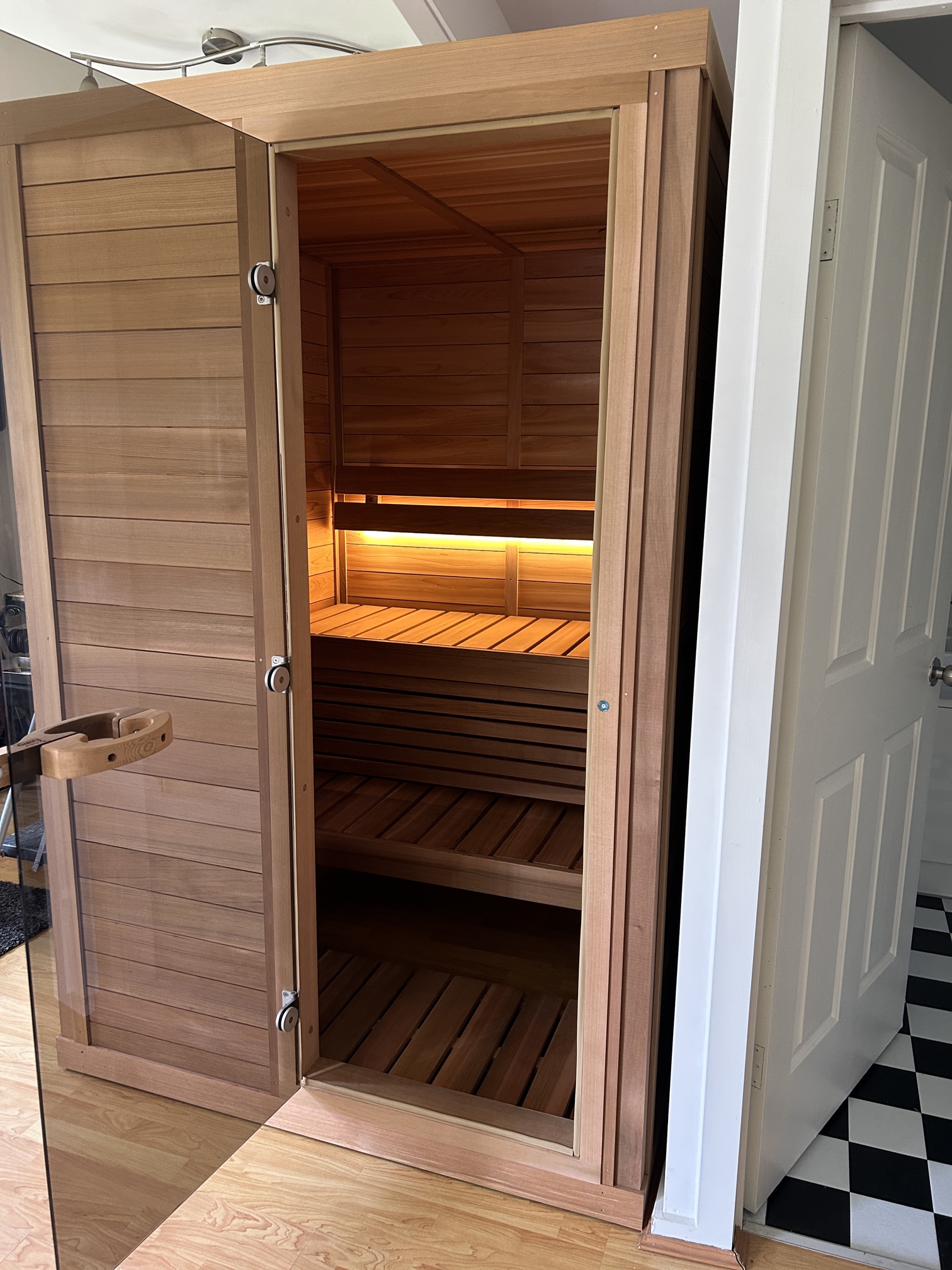 Traditional wooden sauna installation with internal light wired by Ferguson Electrical in Seaford