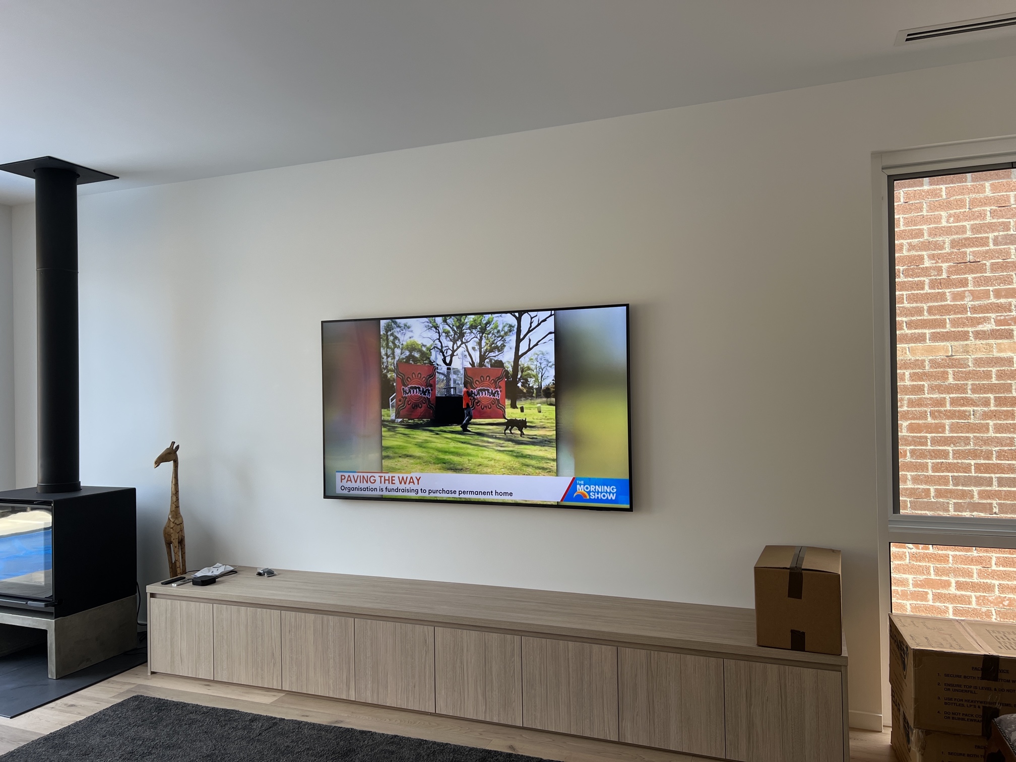 Wall-mounted Smart TV installed by Ferguson Electrical in a modern Beaumaris living room with concealed cables and HDMI points.