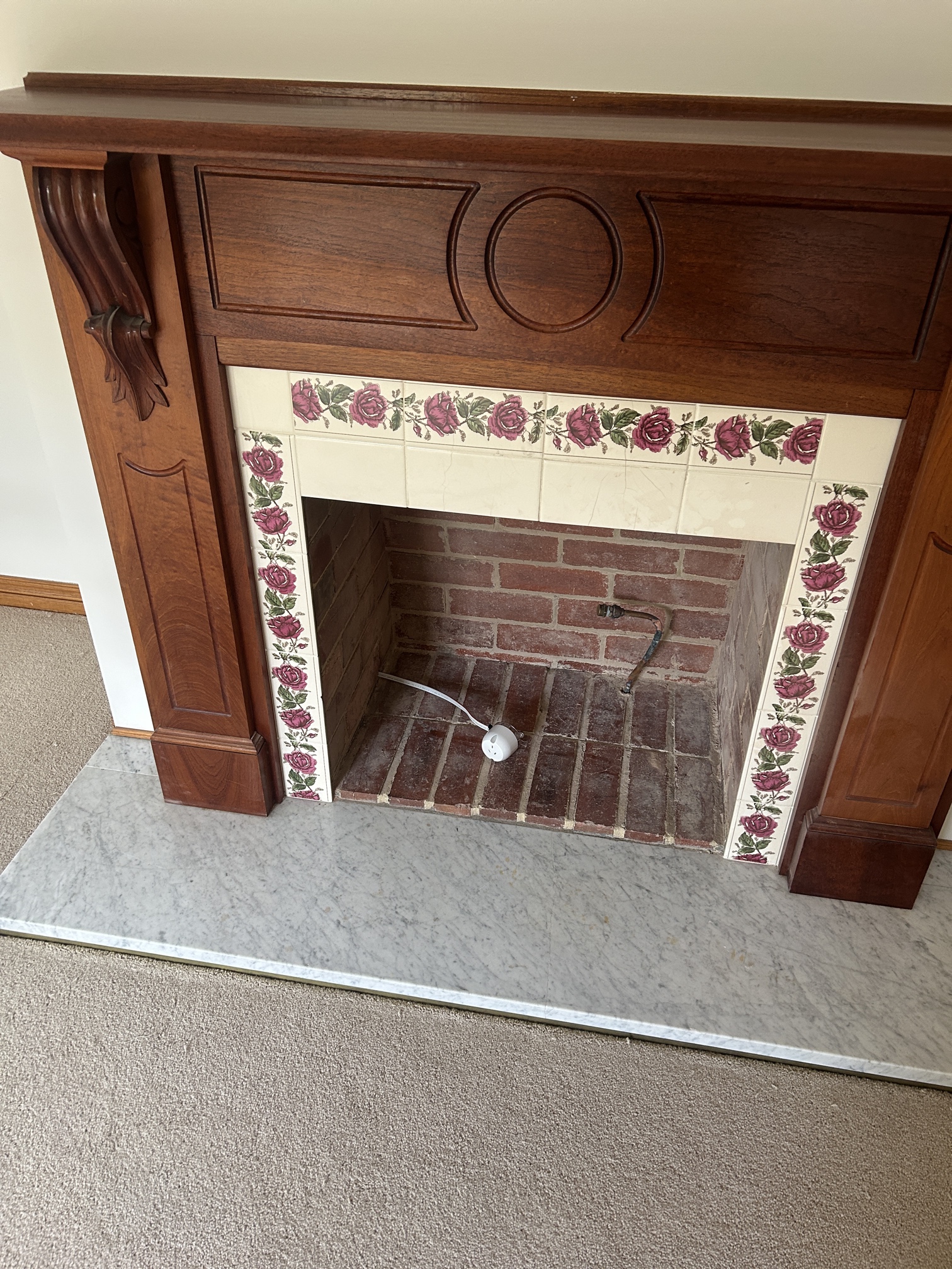PowerPoint and plug base installed near a fireplace for new woodfire setup in Brighton home, by Ferguson Electrical and Al Mac Plumbing.