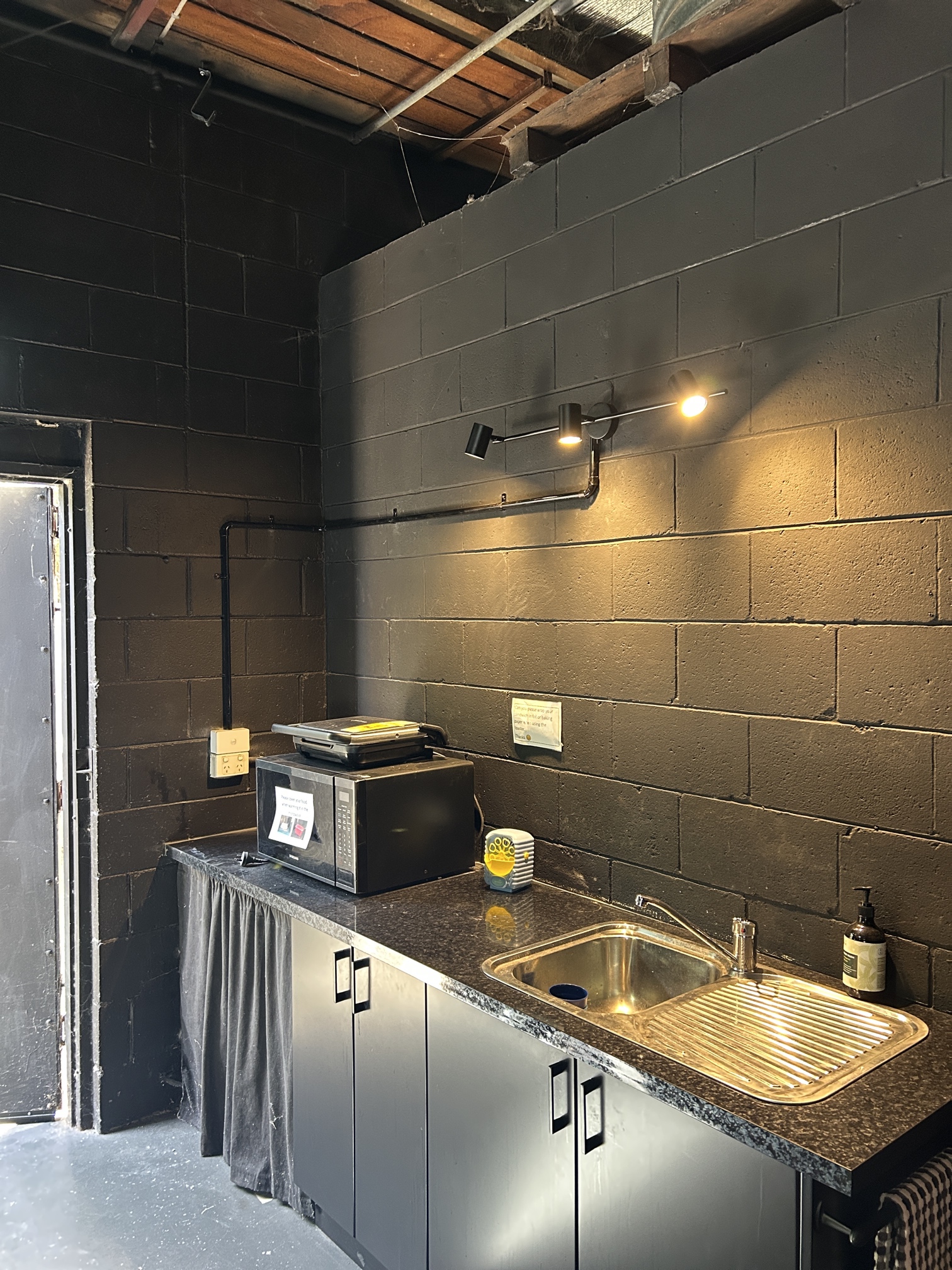 Track lighting installation above kitchenette at BAM Arts Frankston