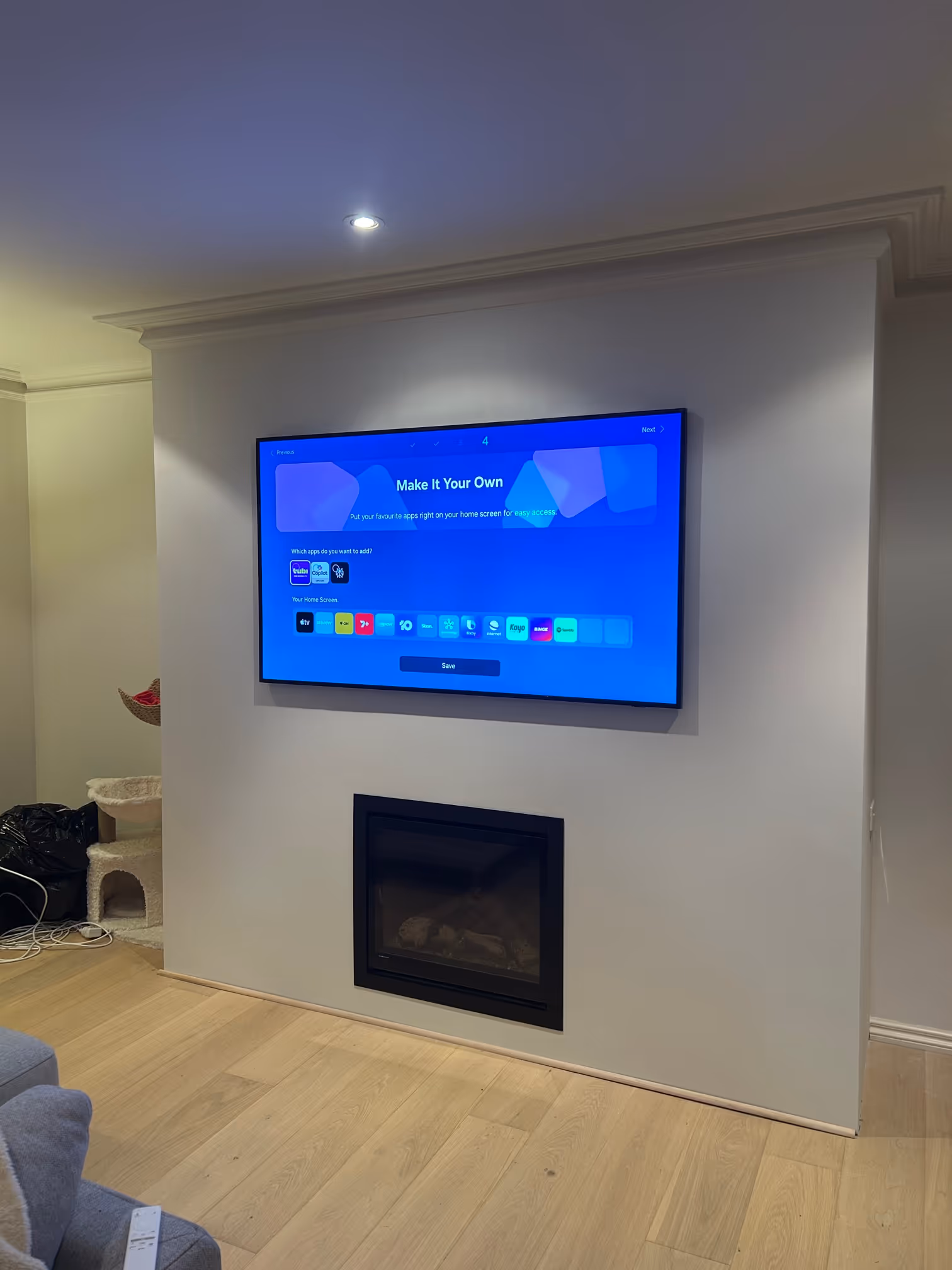 Samsung Frame TV mounted above gas log fireplace in custom media wall installation completed by Ferguson Electrical in Surrey Hills.