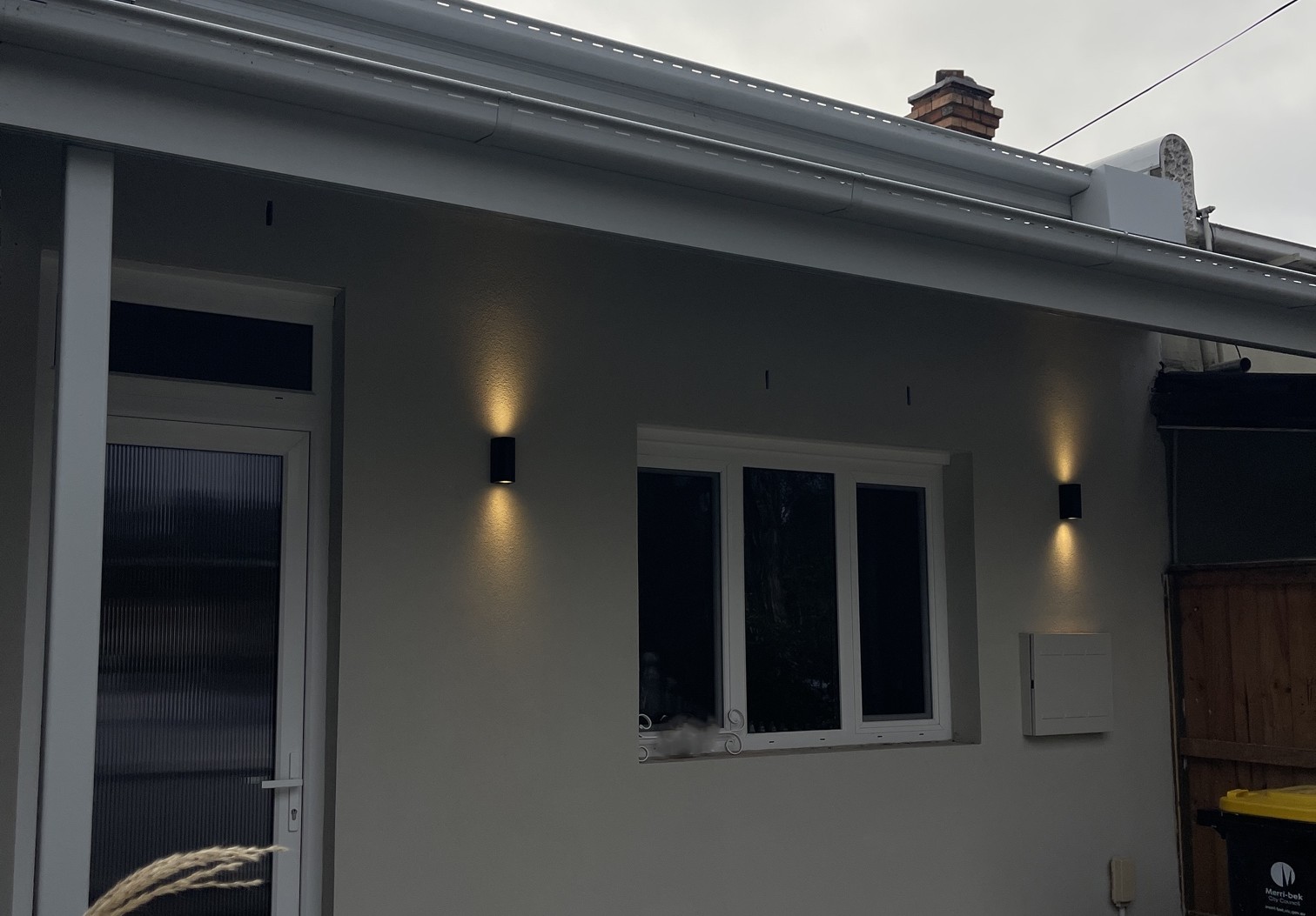 Modern black LED up and down wall lights installed on the front and rear exterior of a renovated home in Patterson Lakes by Ferguson Electrical.