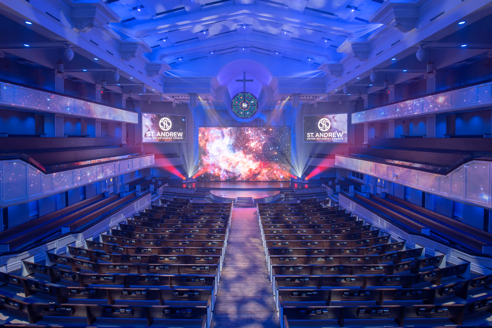 Worship sanctuary with stage, projection screen, and FOH audio console