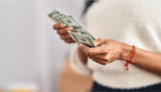 Woman counting money with her hands.