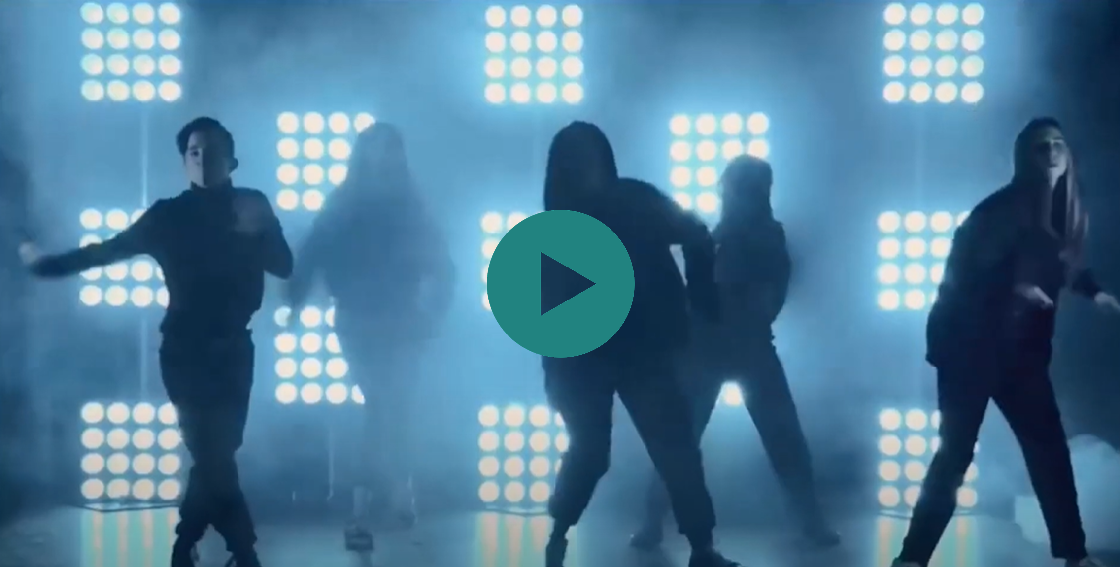 A group of four women dancing in front of a green screen.