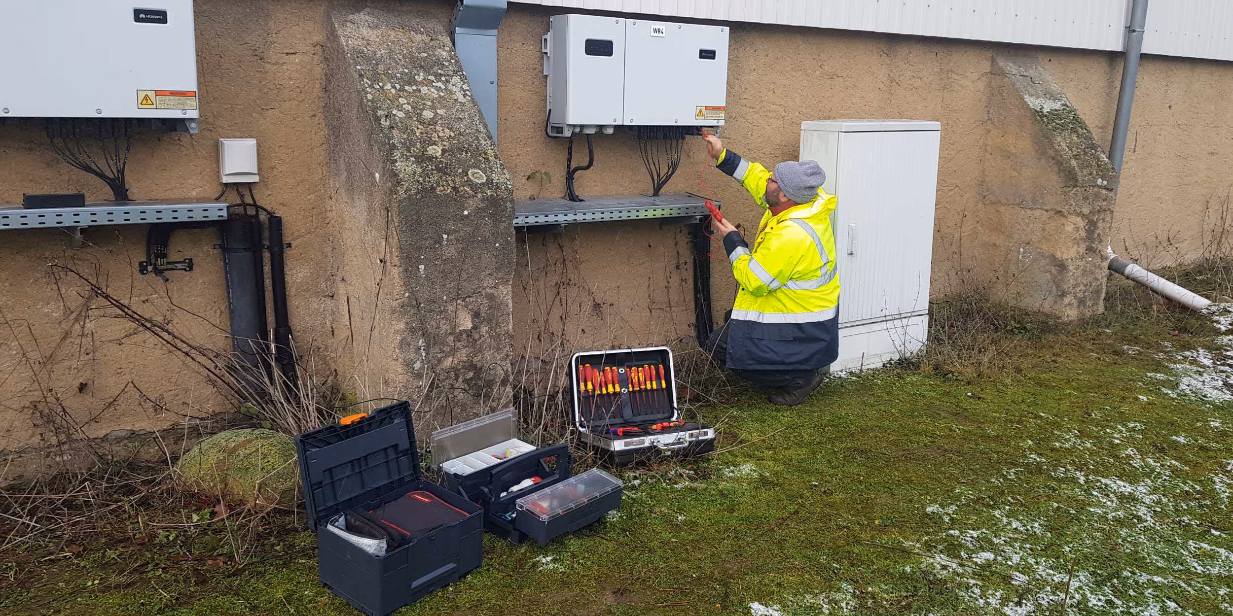8.2 employee inspecting electrical setup of PV