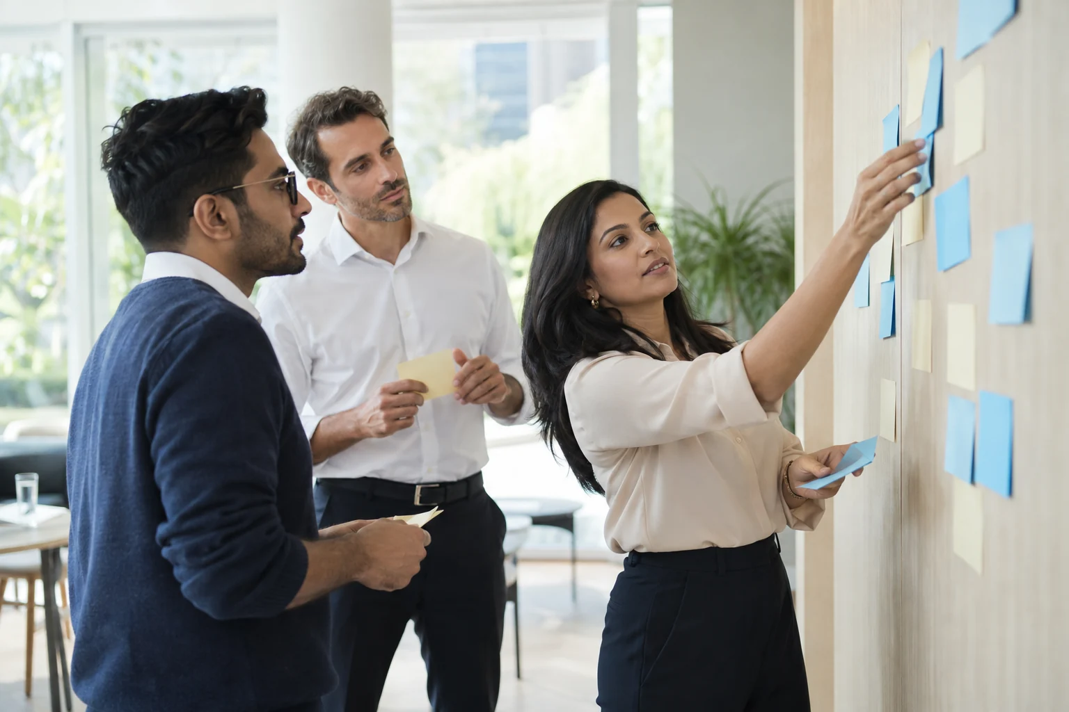 A workshop team mapping business workflow steps and review points.