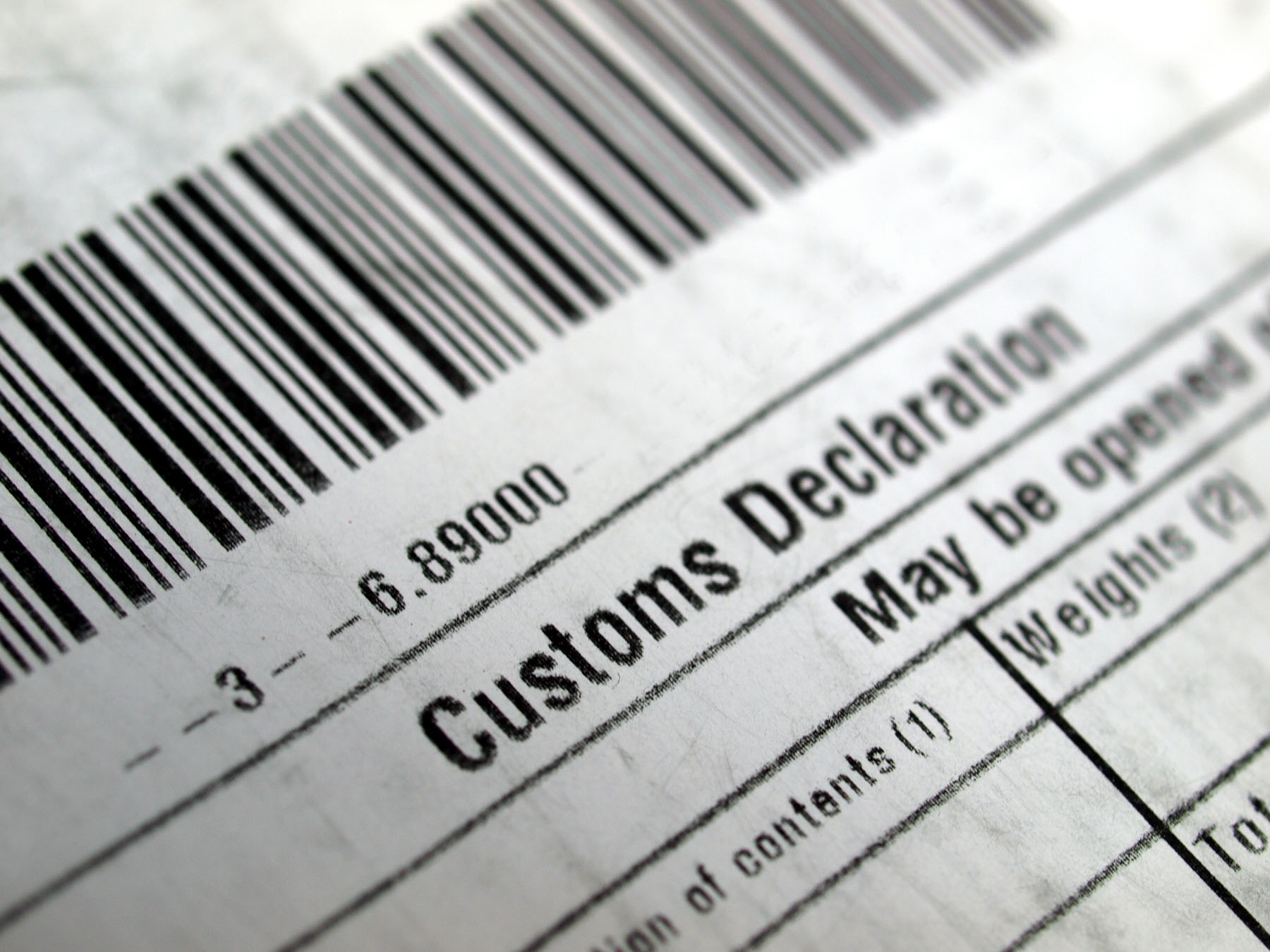 Close-up of a customs declaration form with visible barcode and section labeled "Customs Declaration."