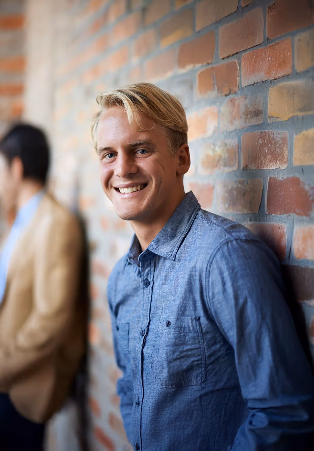 A young man looking at the camera smiling