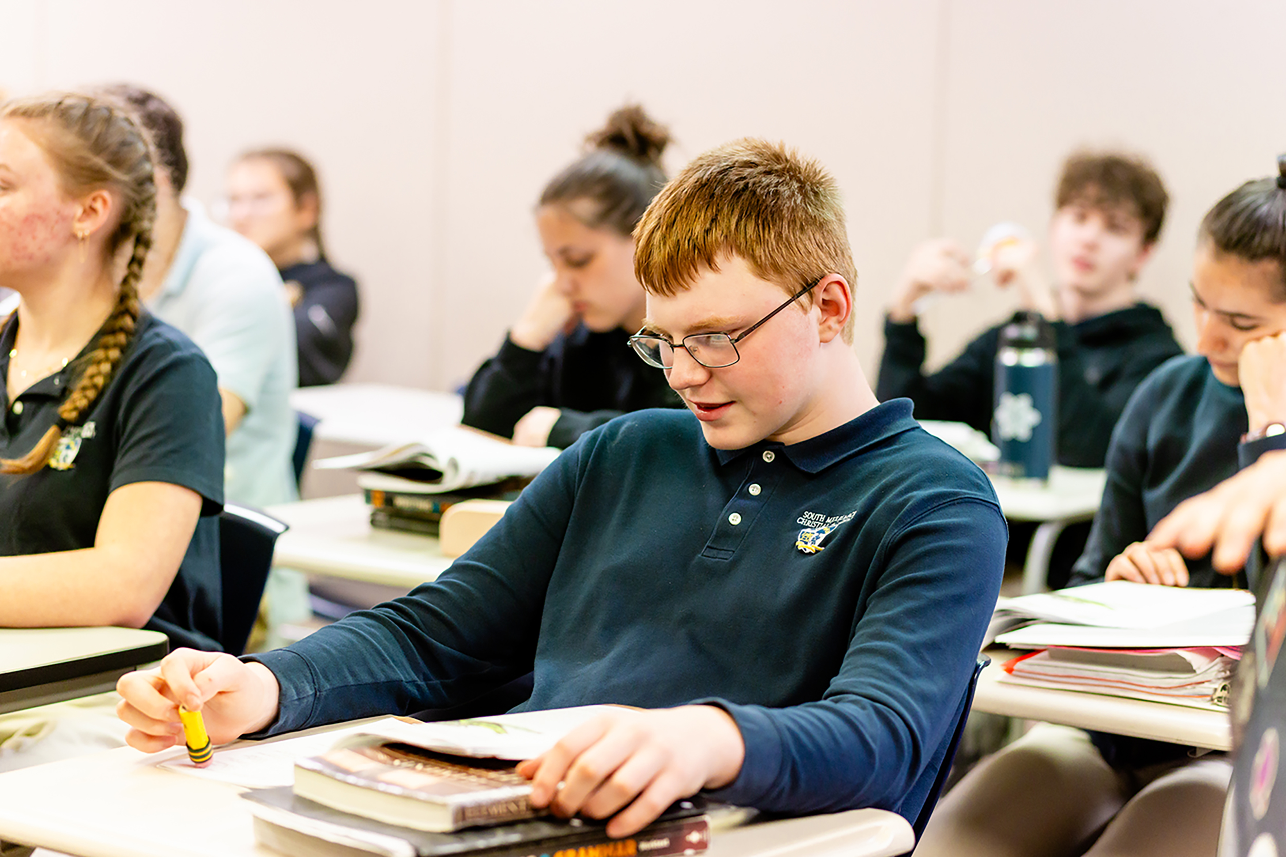 High School student sitting at his desk in class